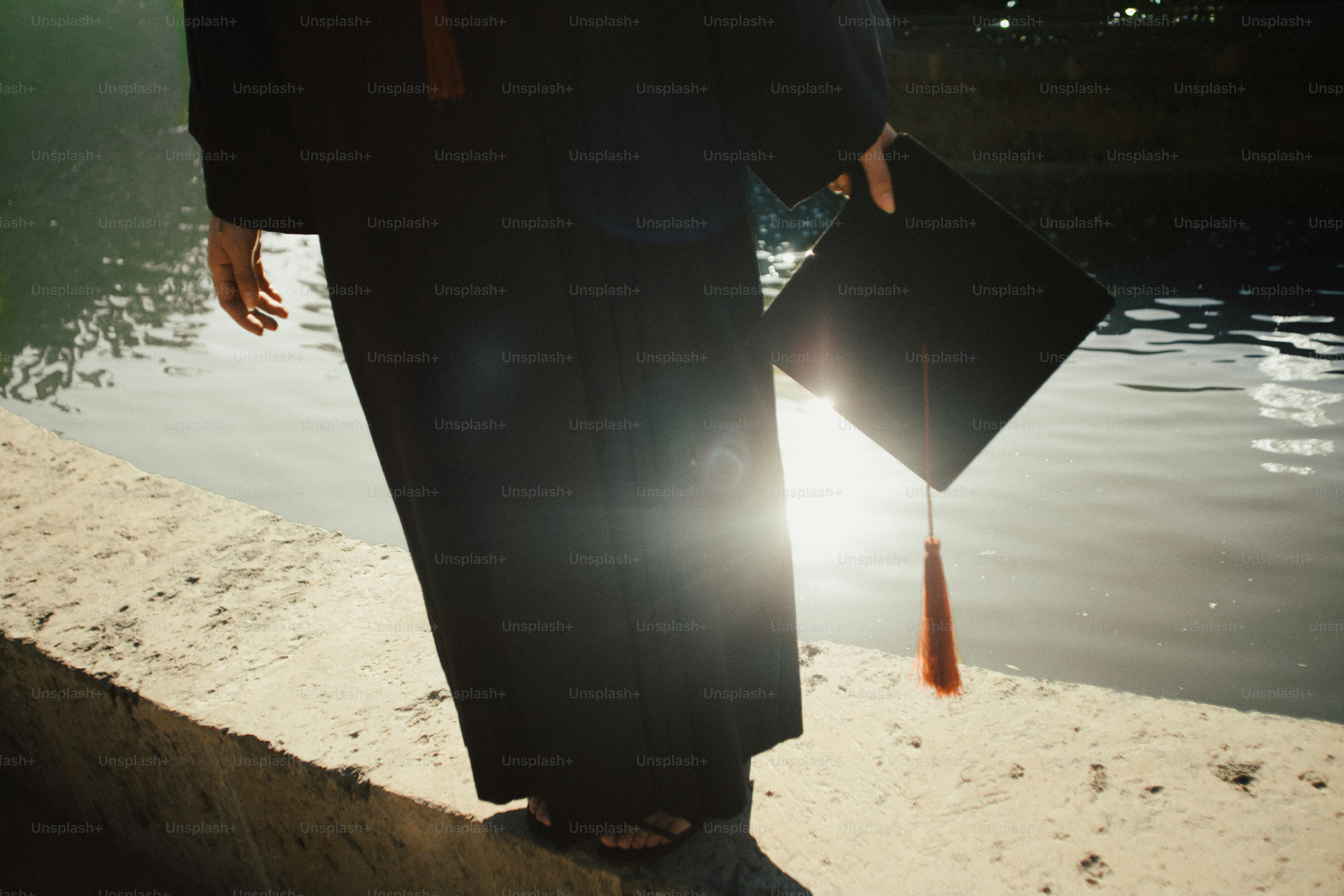 Graduation cap and gown by the water photo – Education Image on Unsplash