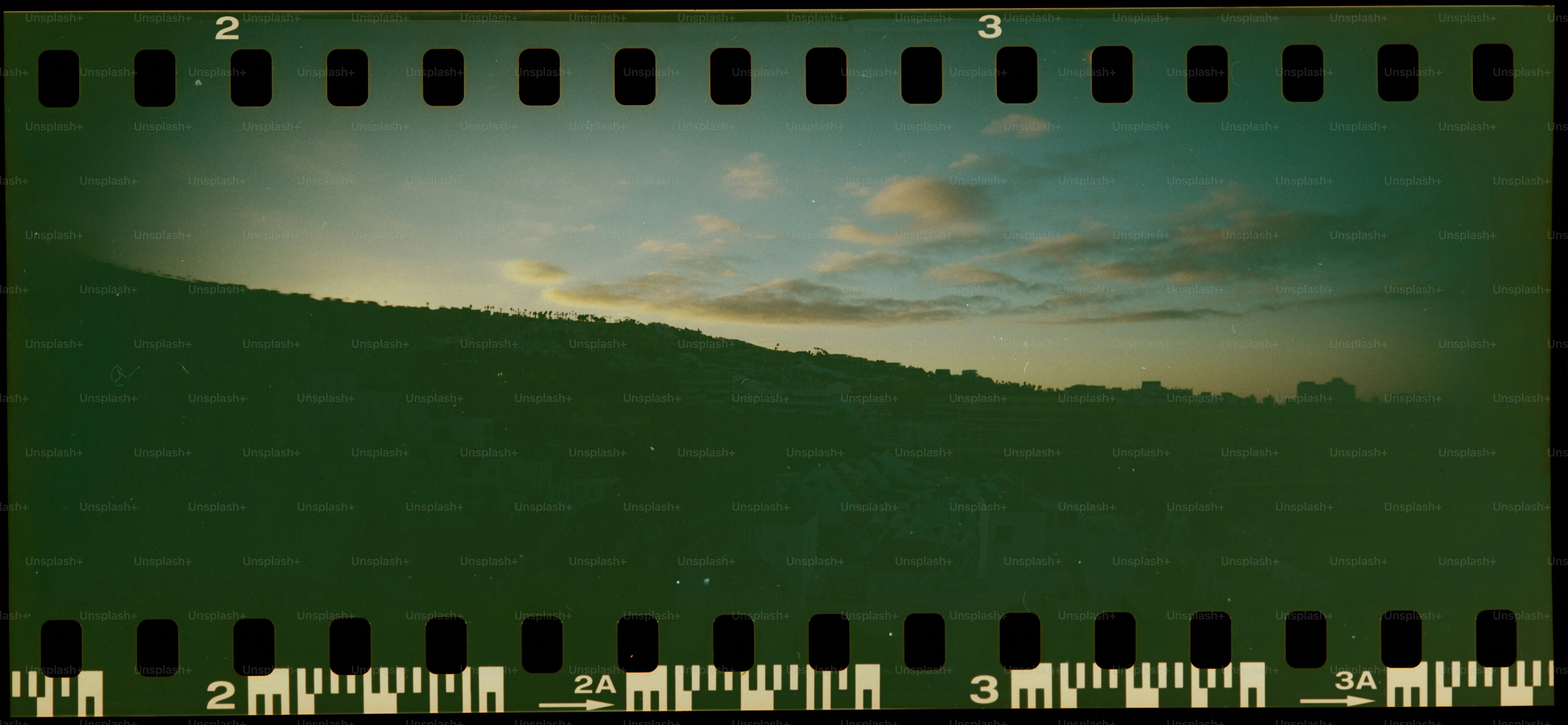 Green rolling hills under a cloudy sky.