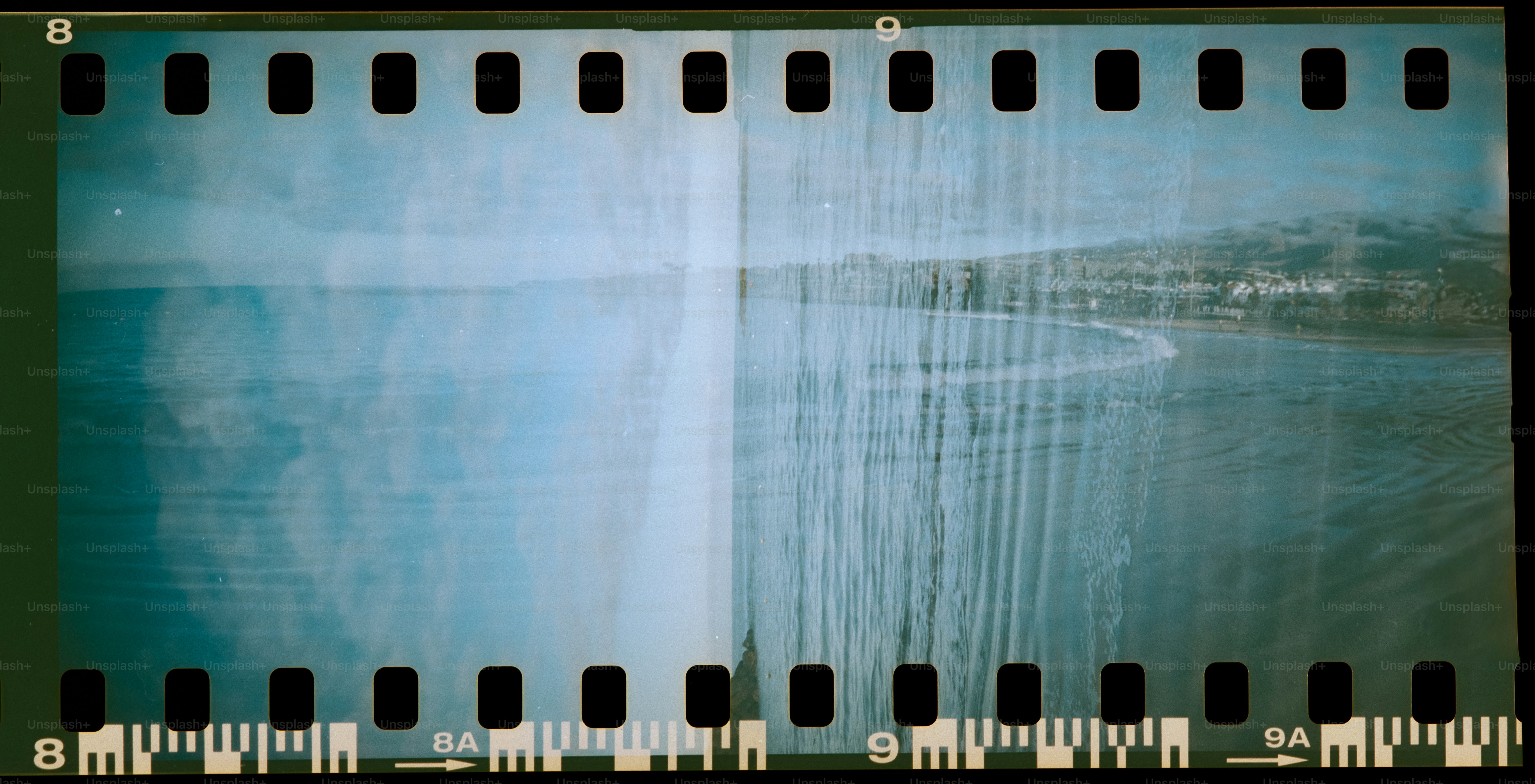 A vintage film strip with a blurry landscape.