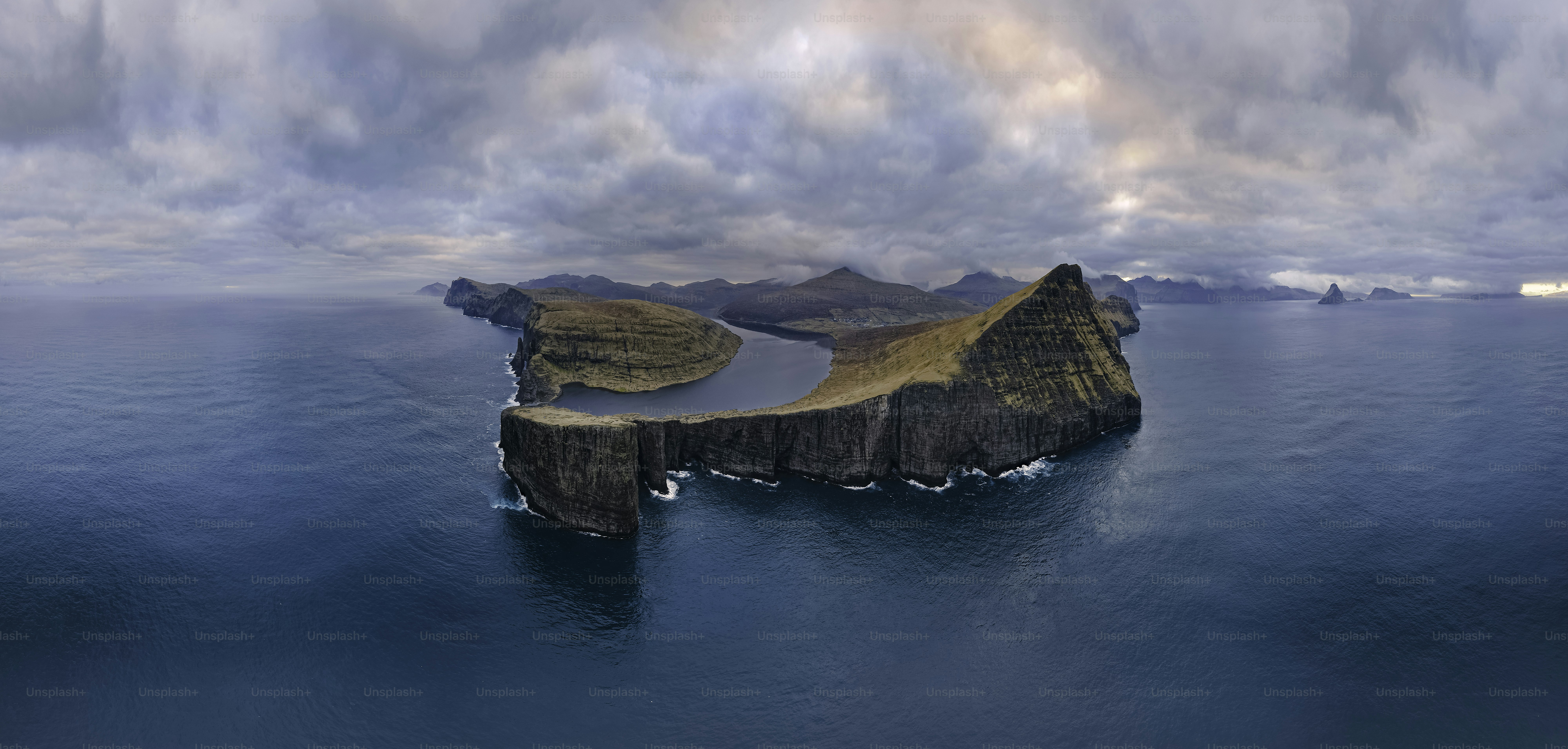 Rocky island surrounded by calm blue ocean water photo – Island Image ...