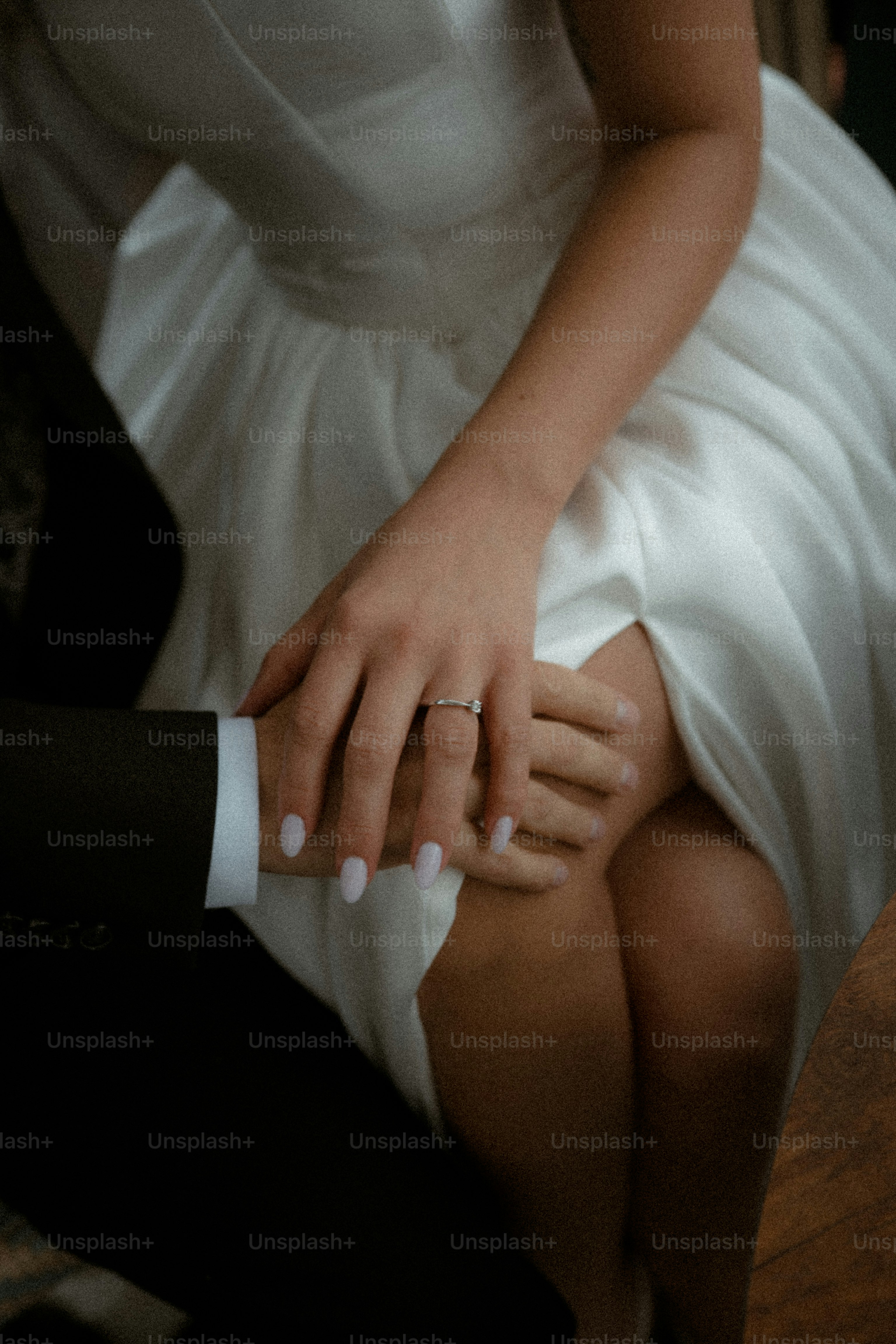 Novio y novio cogidos de la mano, vestidos con atuendo de boda.
