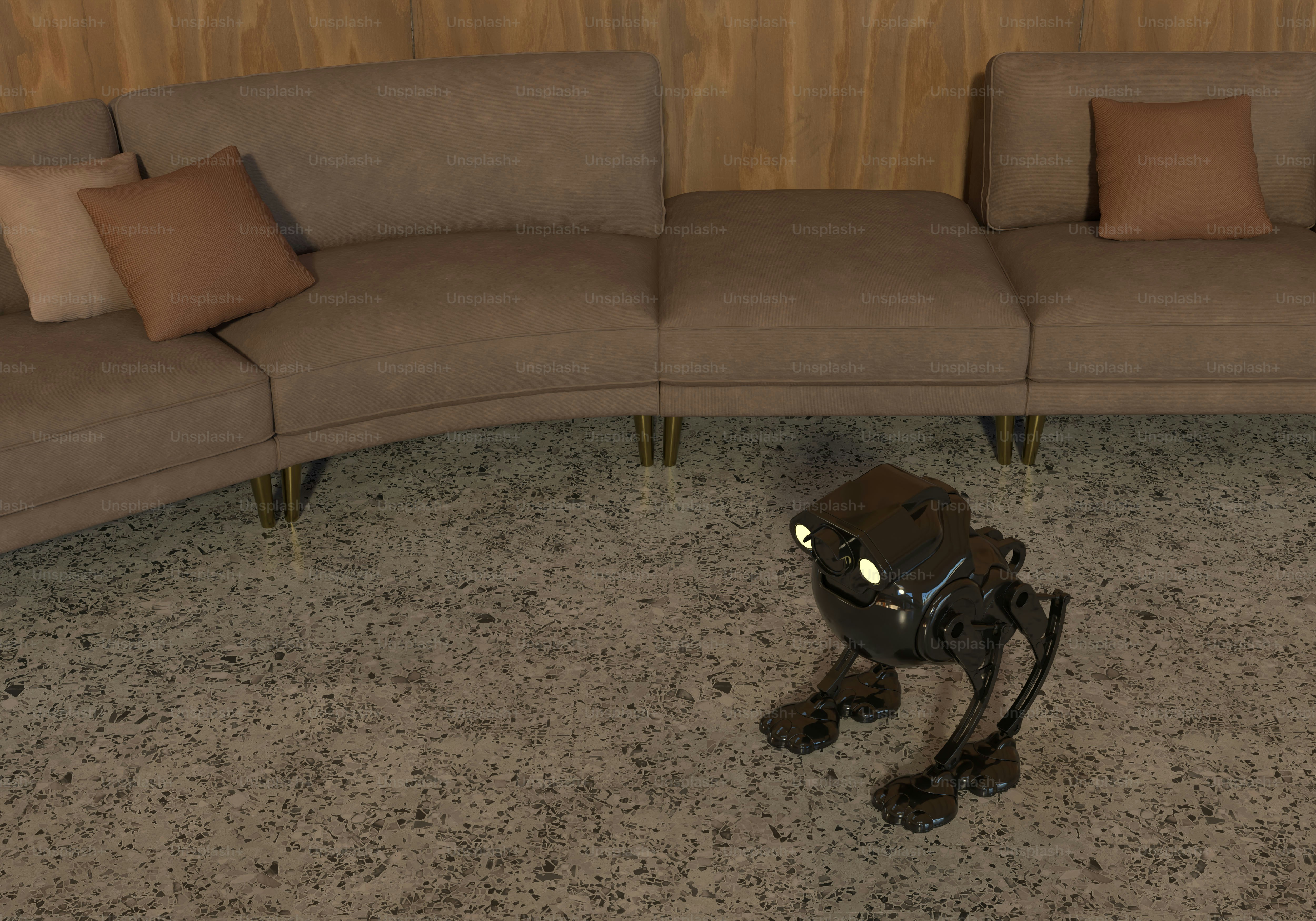 Robot kecil dengan mata bersinar di lantai dekat sofa