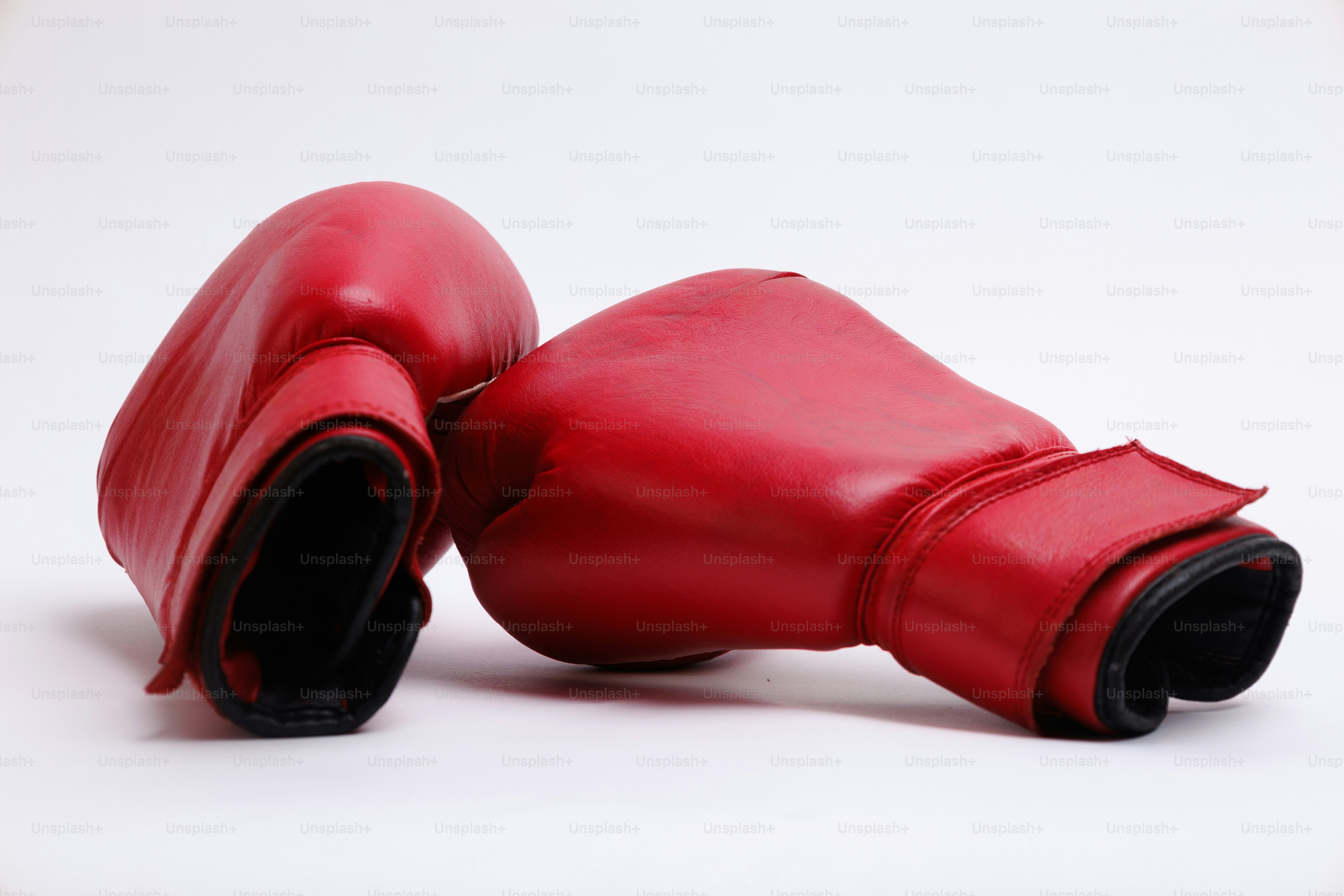 Two red boxing gloves on a white background.