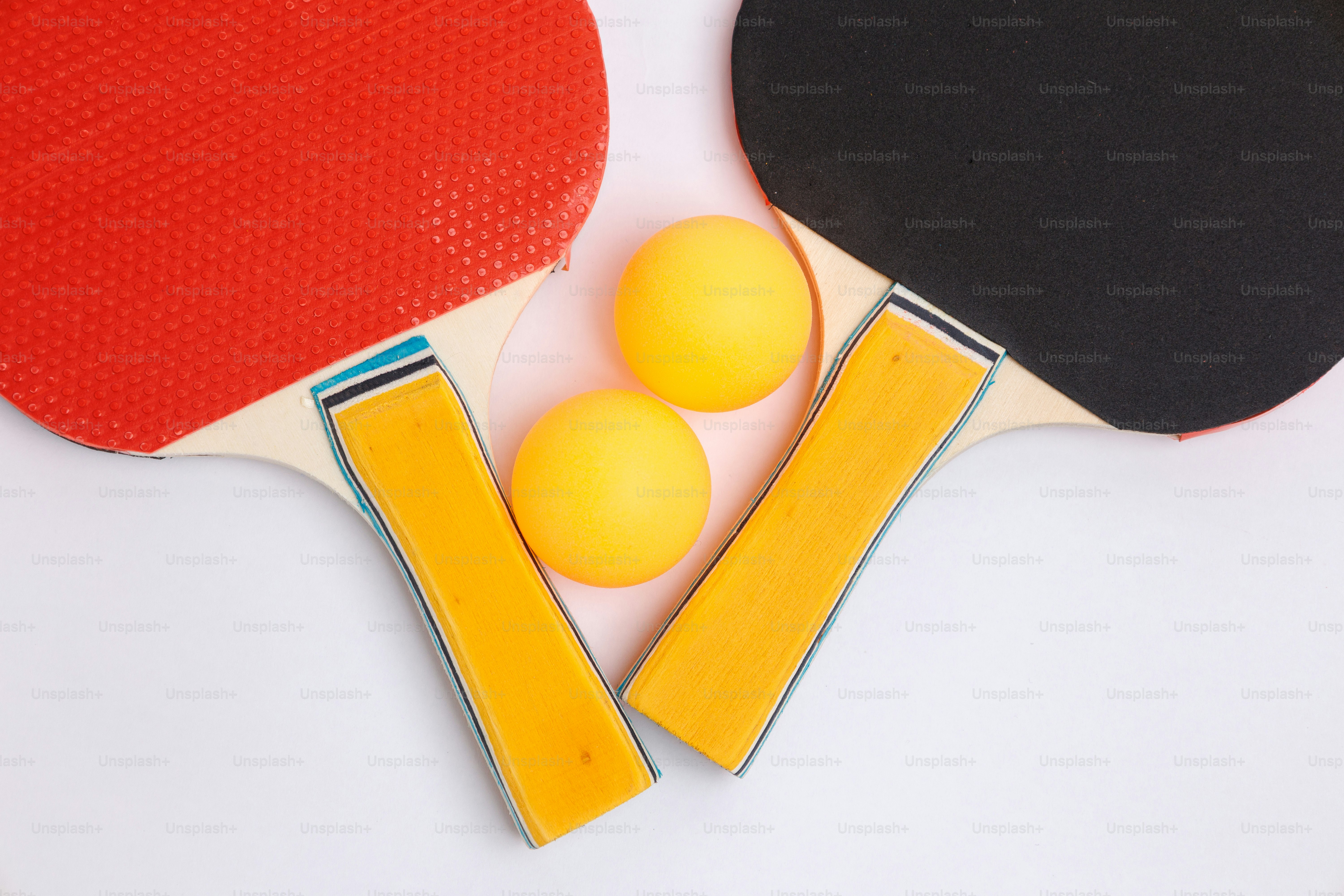 Two ping pong paddles and two balls
