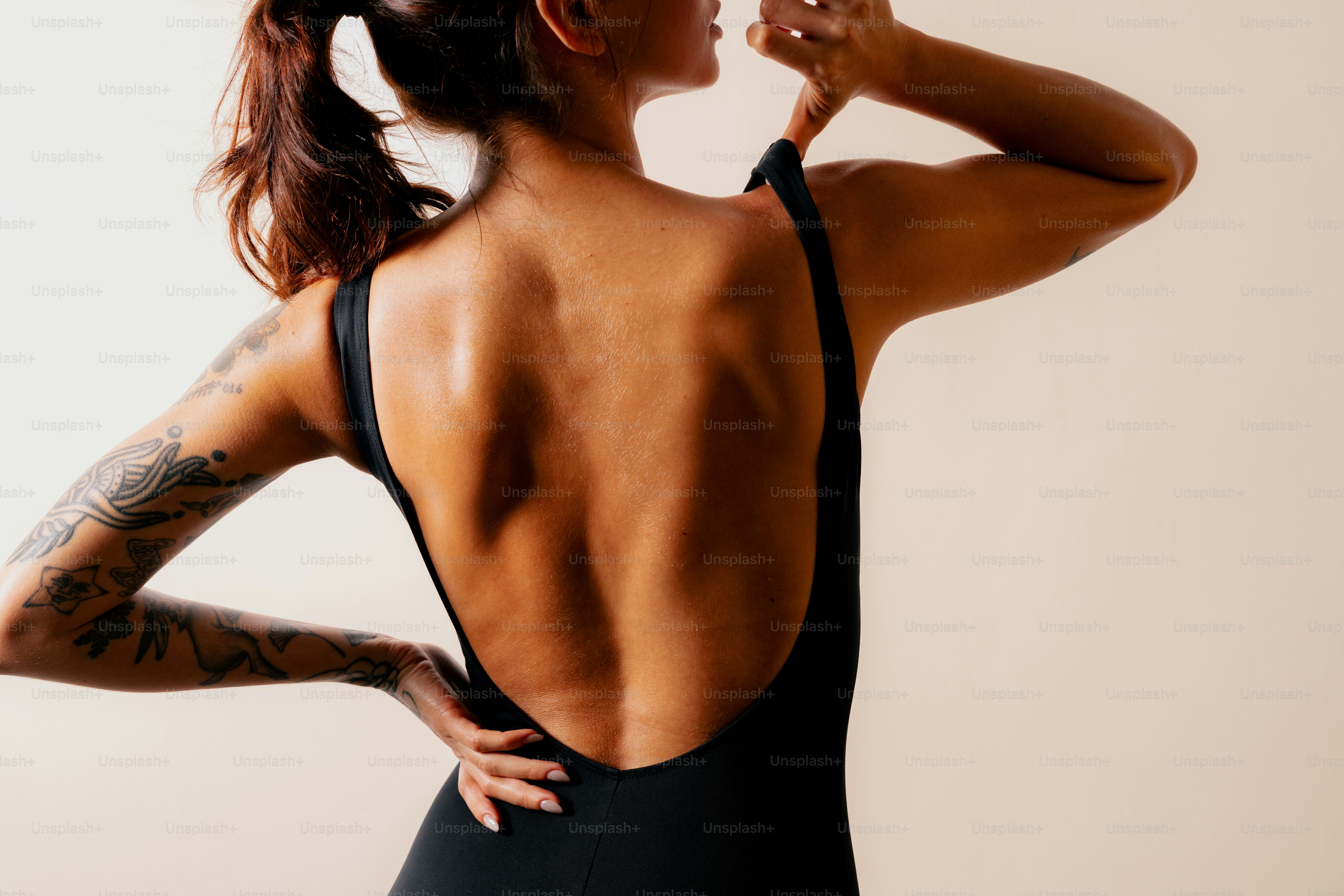 Woman in black swimsuit showing her back