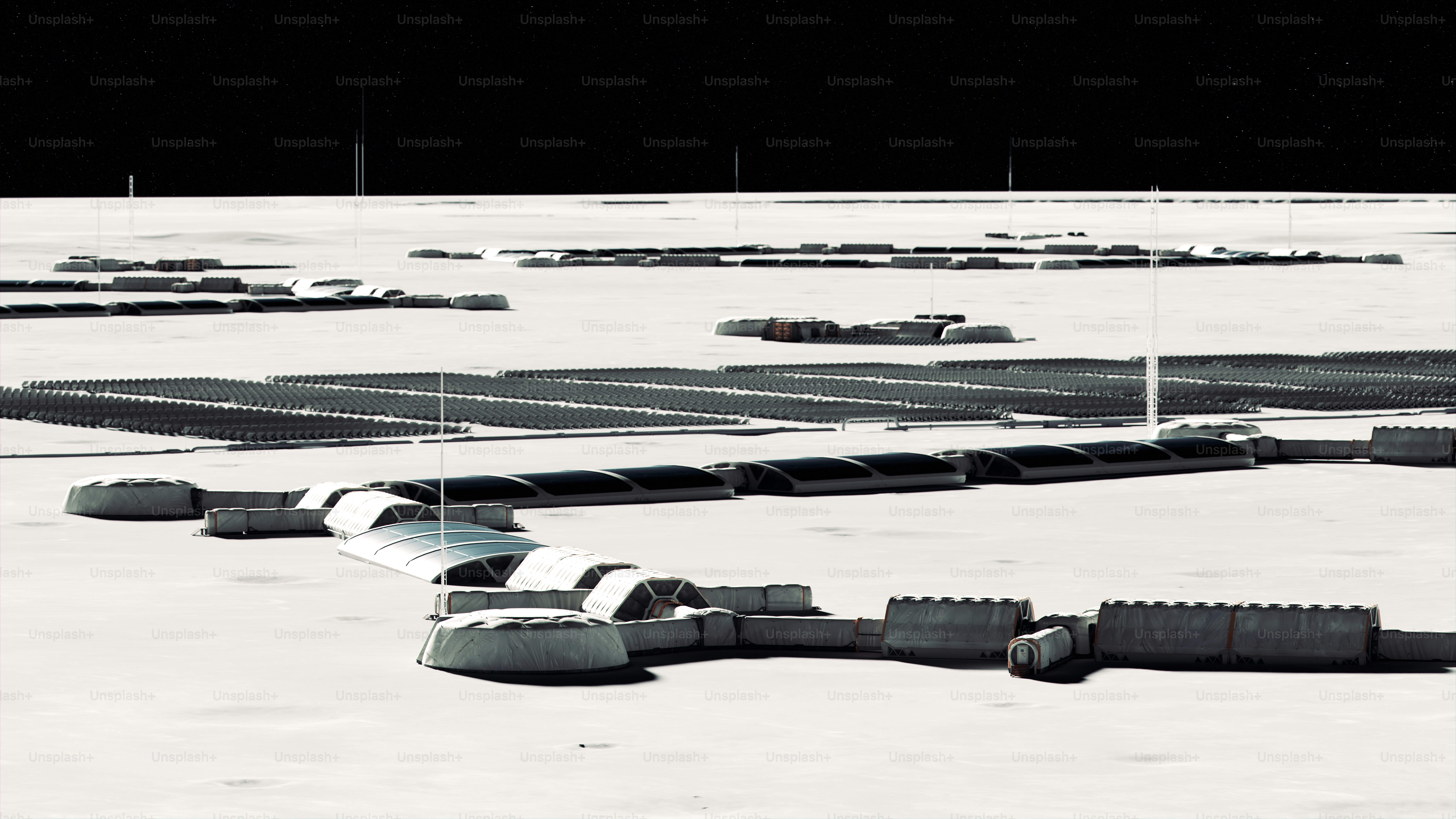 Vista aerea di un insediamento futuristico nel deserto con strutture curve.