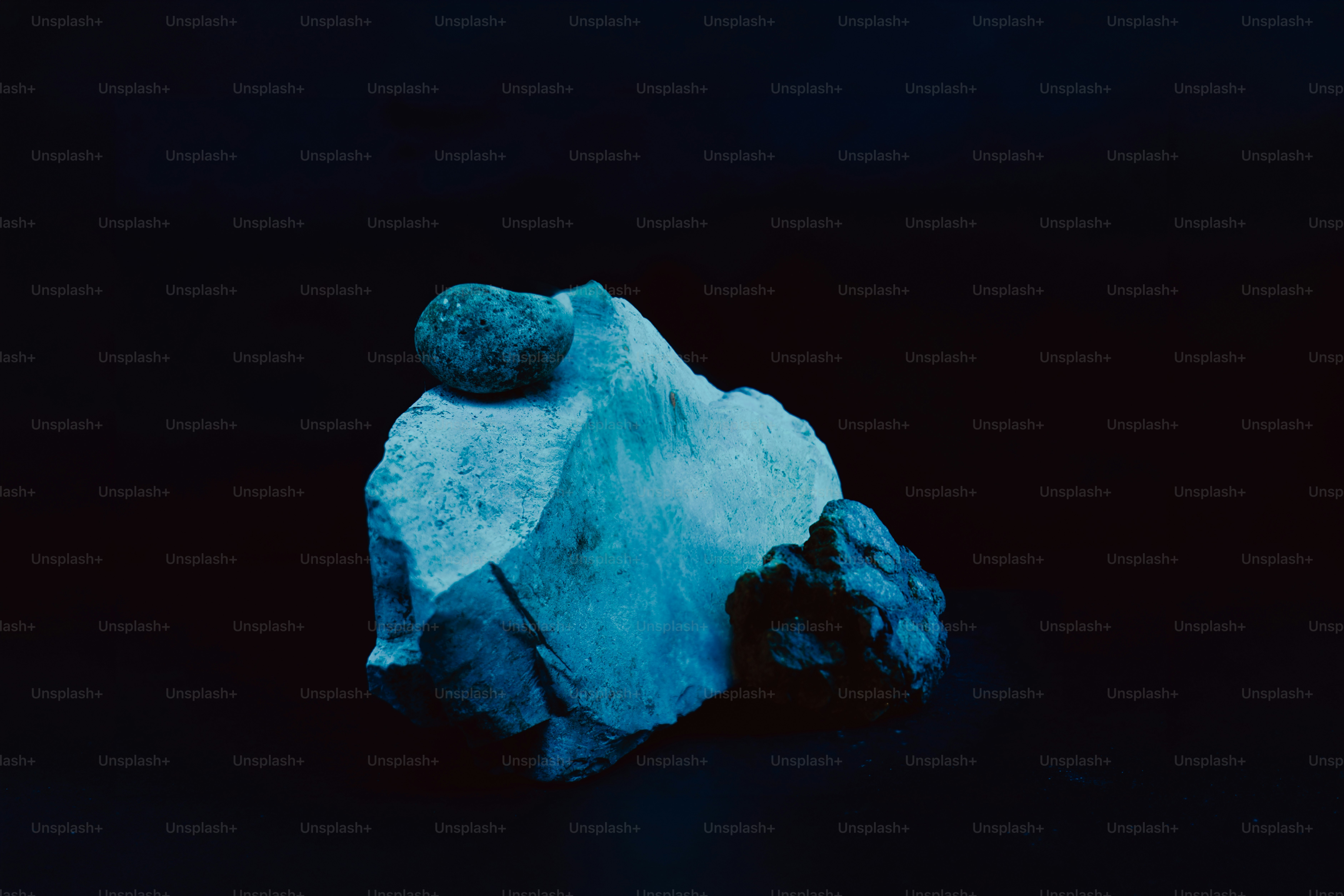 Close-up of two rocks on a dark background