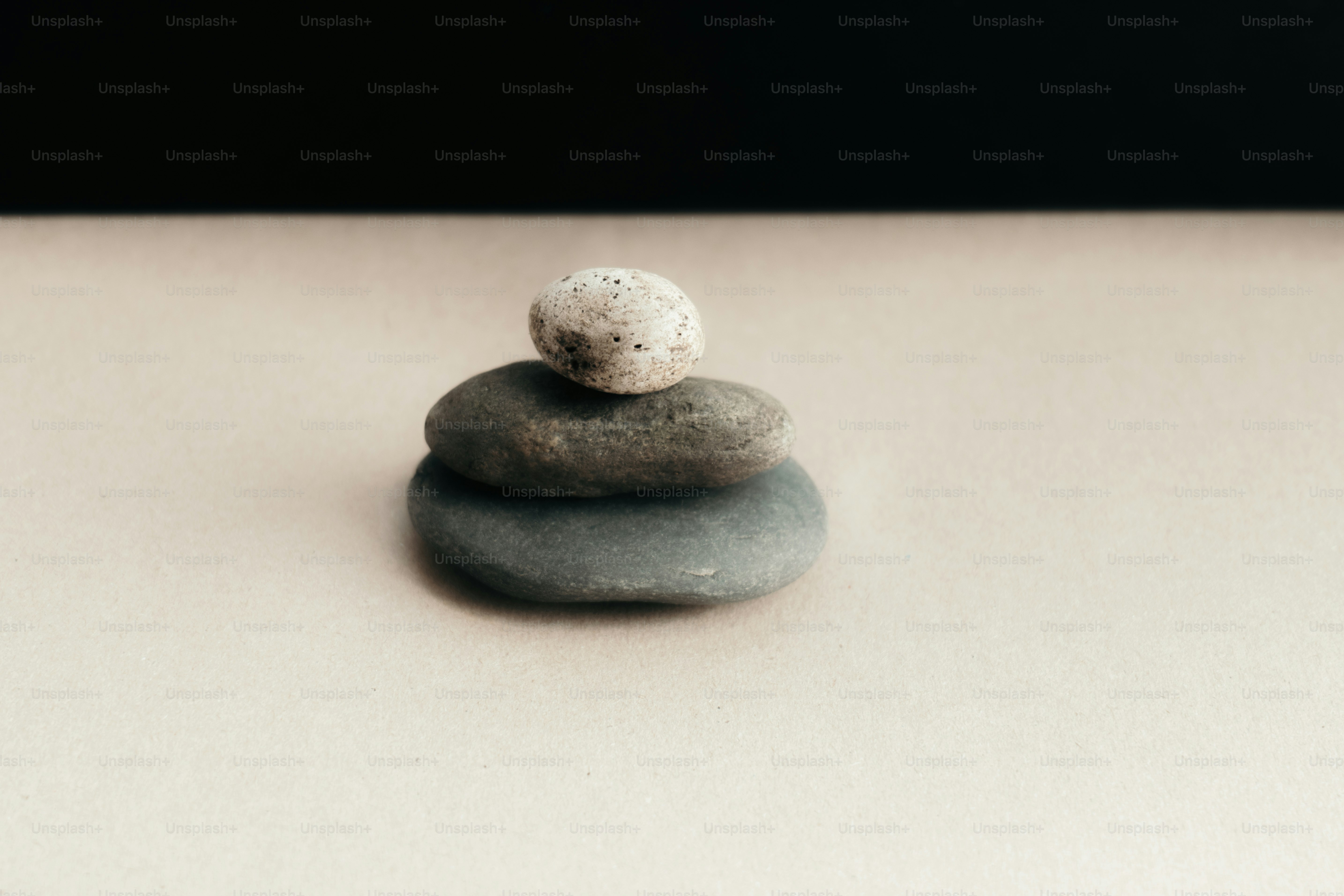Three stacked stones on a neutral surface