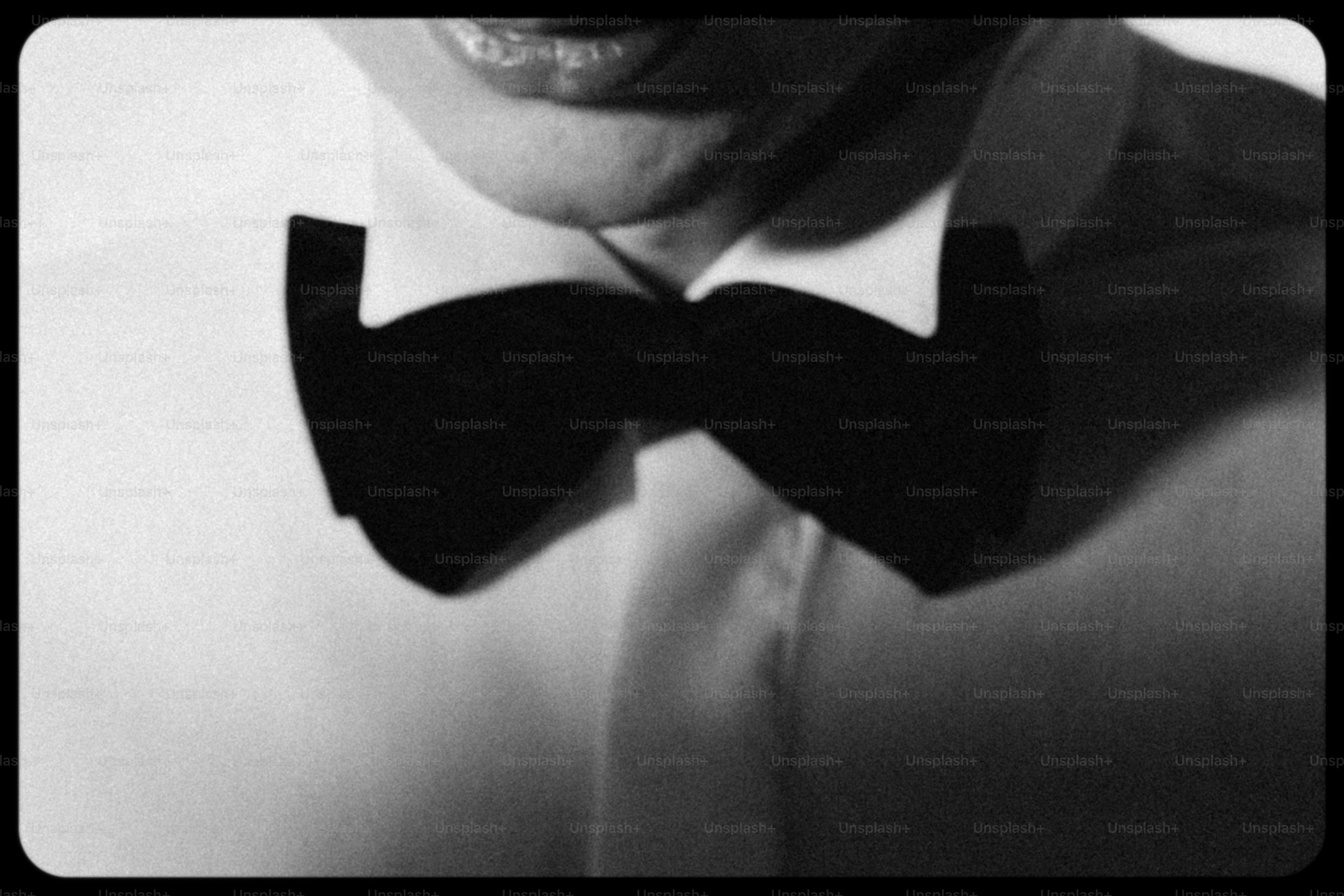 Close-up of a person wearing a black bow tie