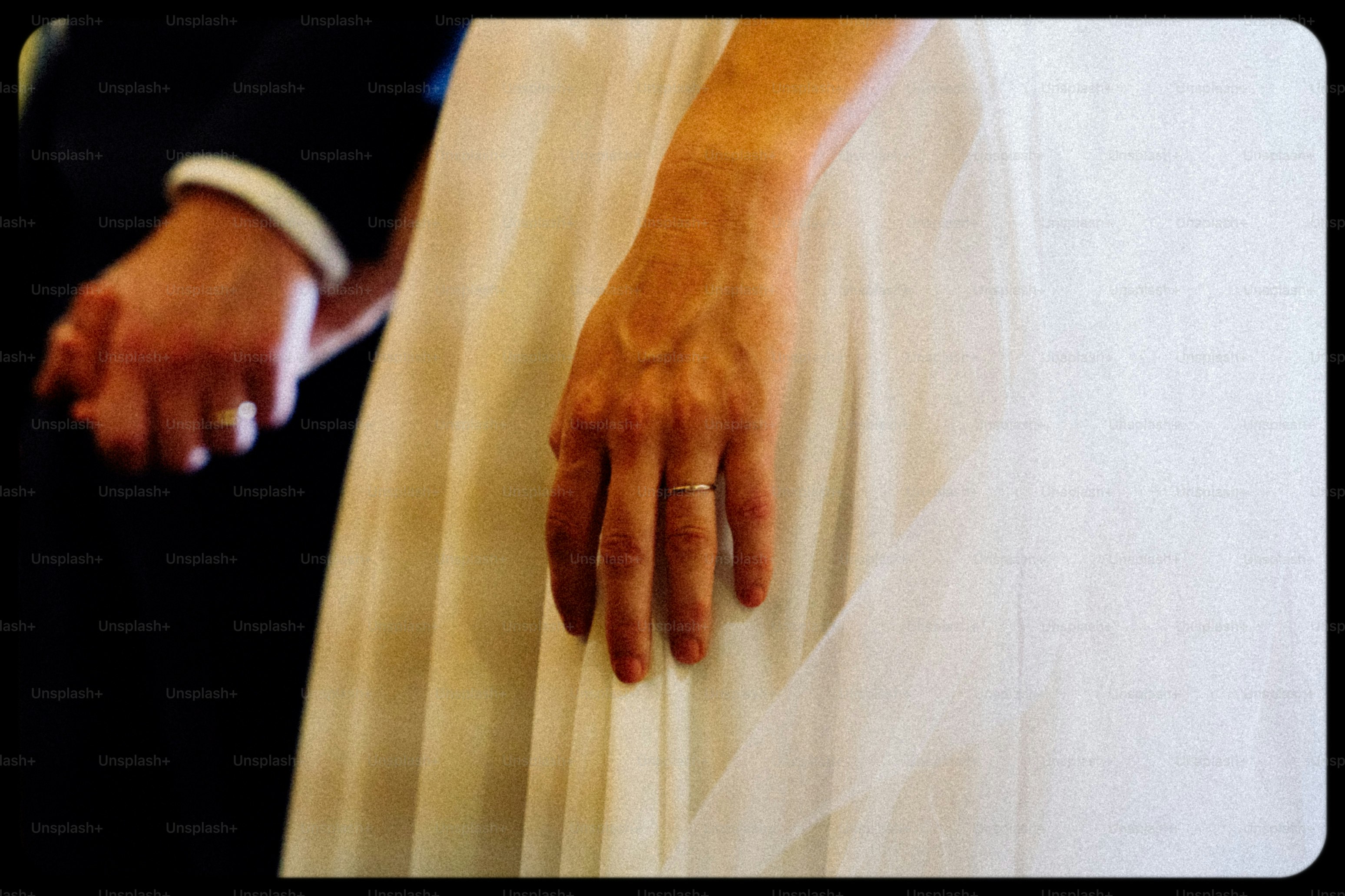 A bride and groom holding hands on wedding day