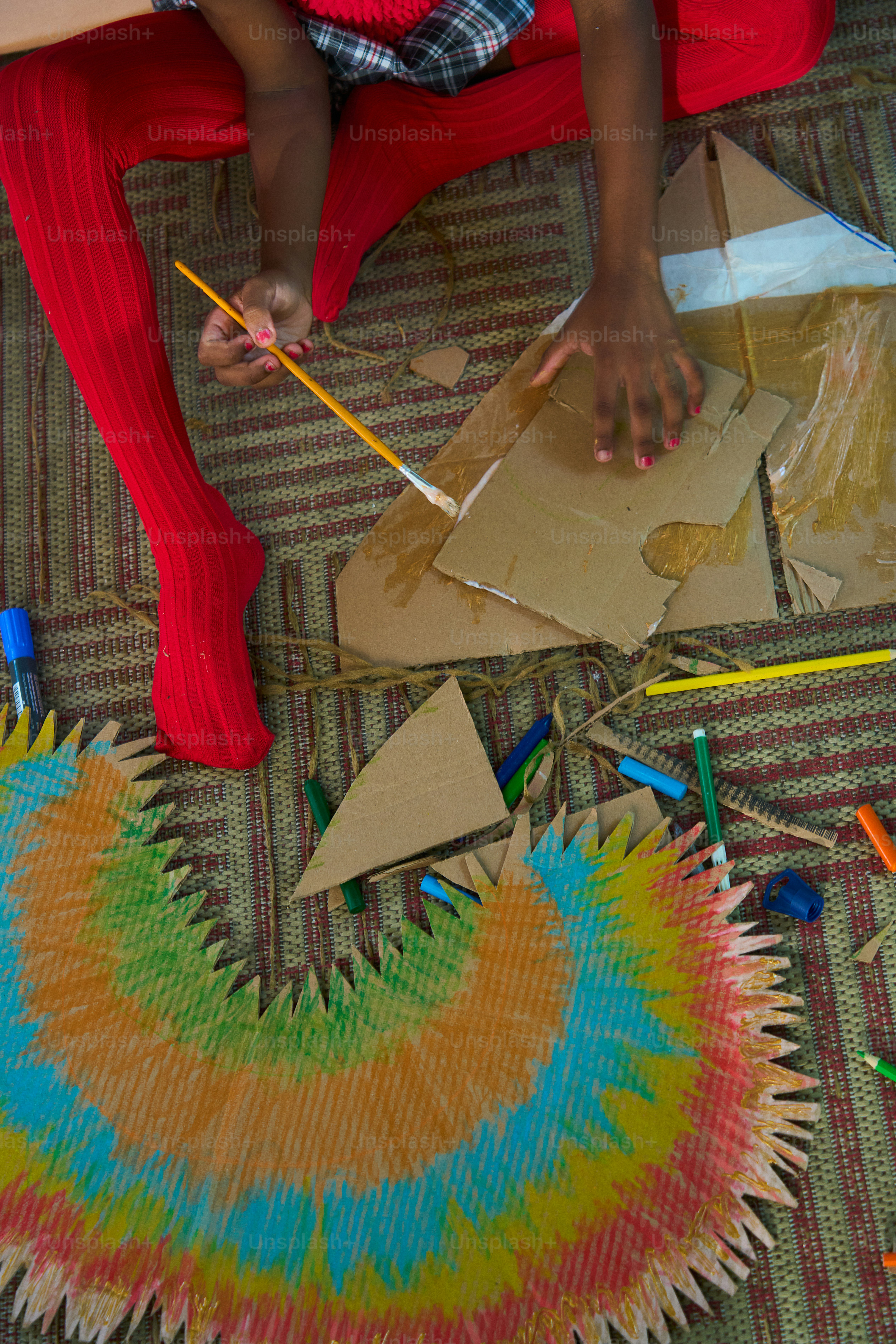 Child creating colorful craft with cardboard and paint. photo ...