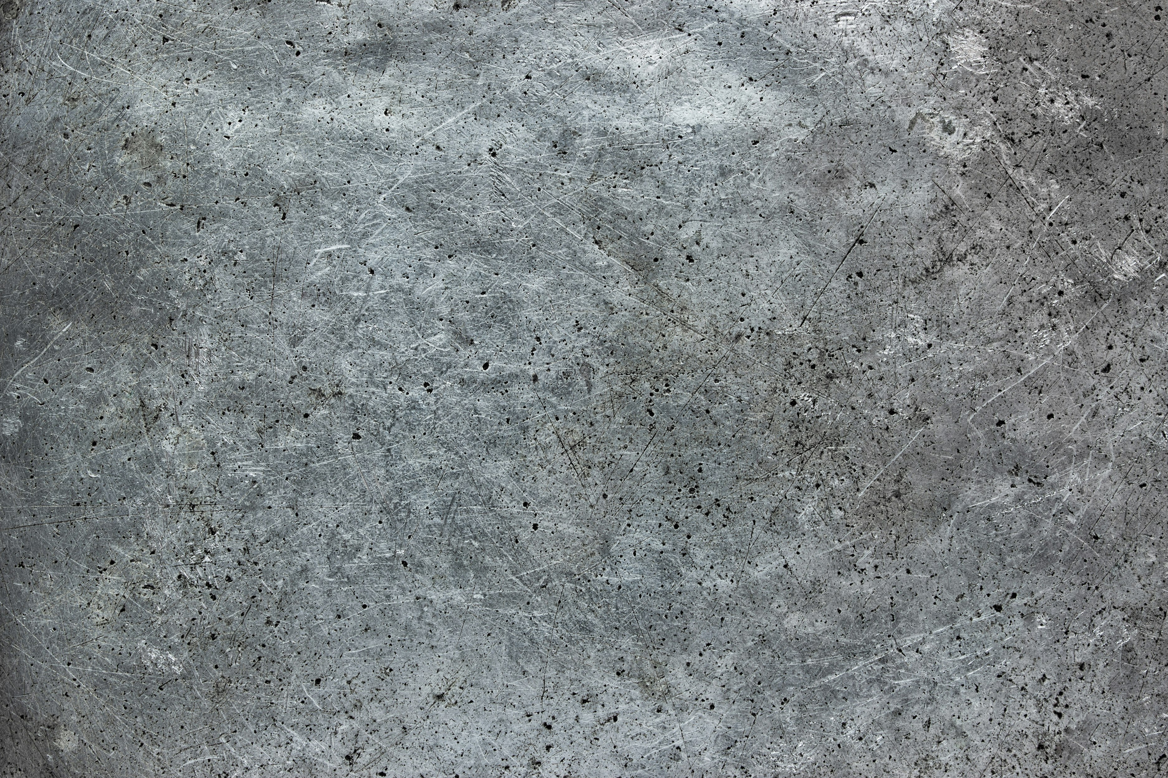 Gray steel surface, brushed metal background with traces of exploitation