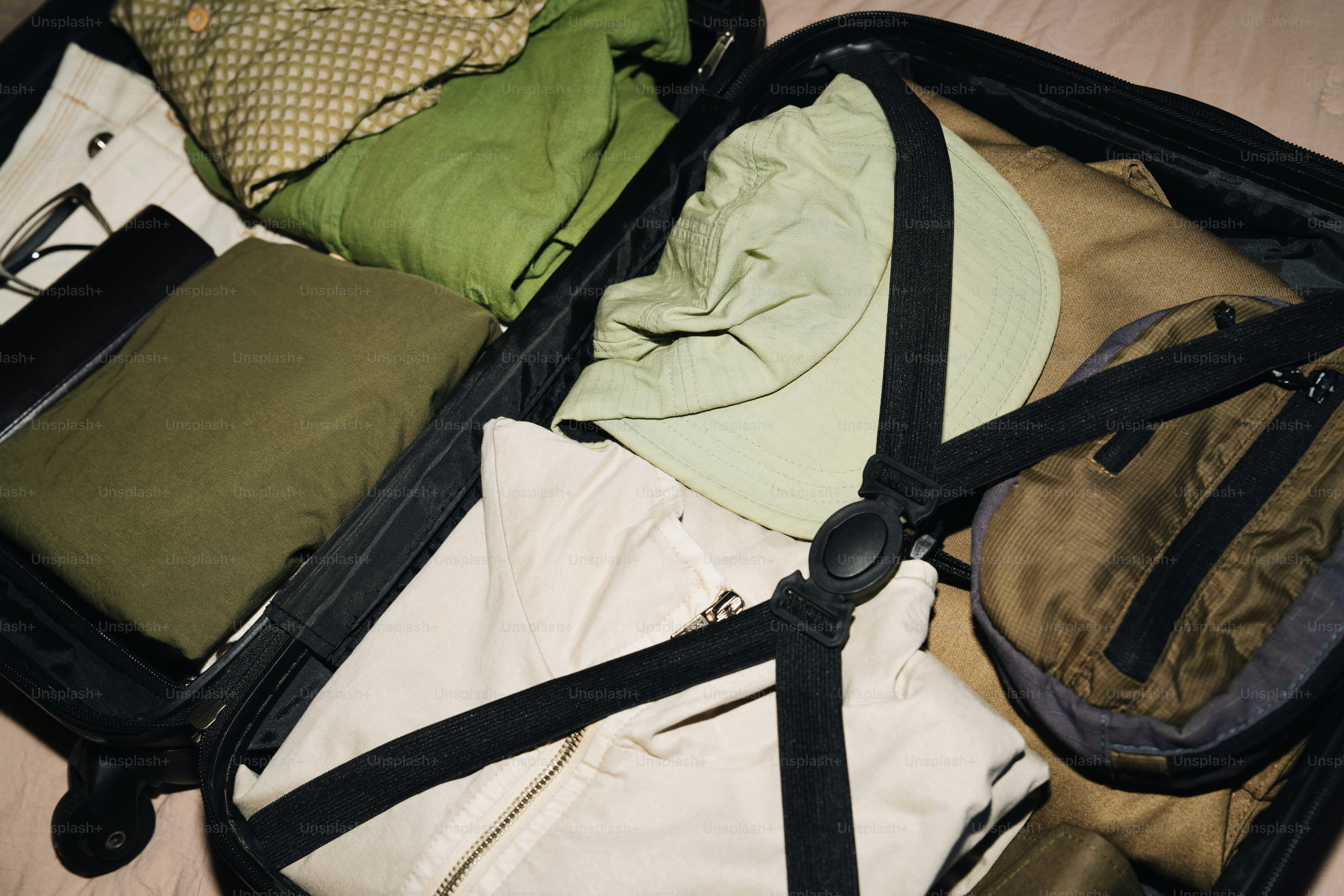 Suitcase packed with clothes and accessories for travel.