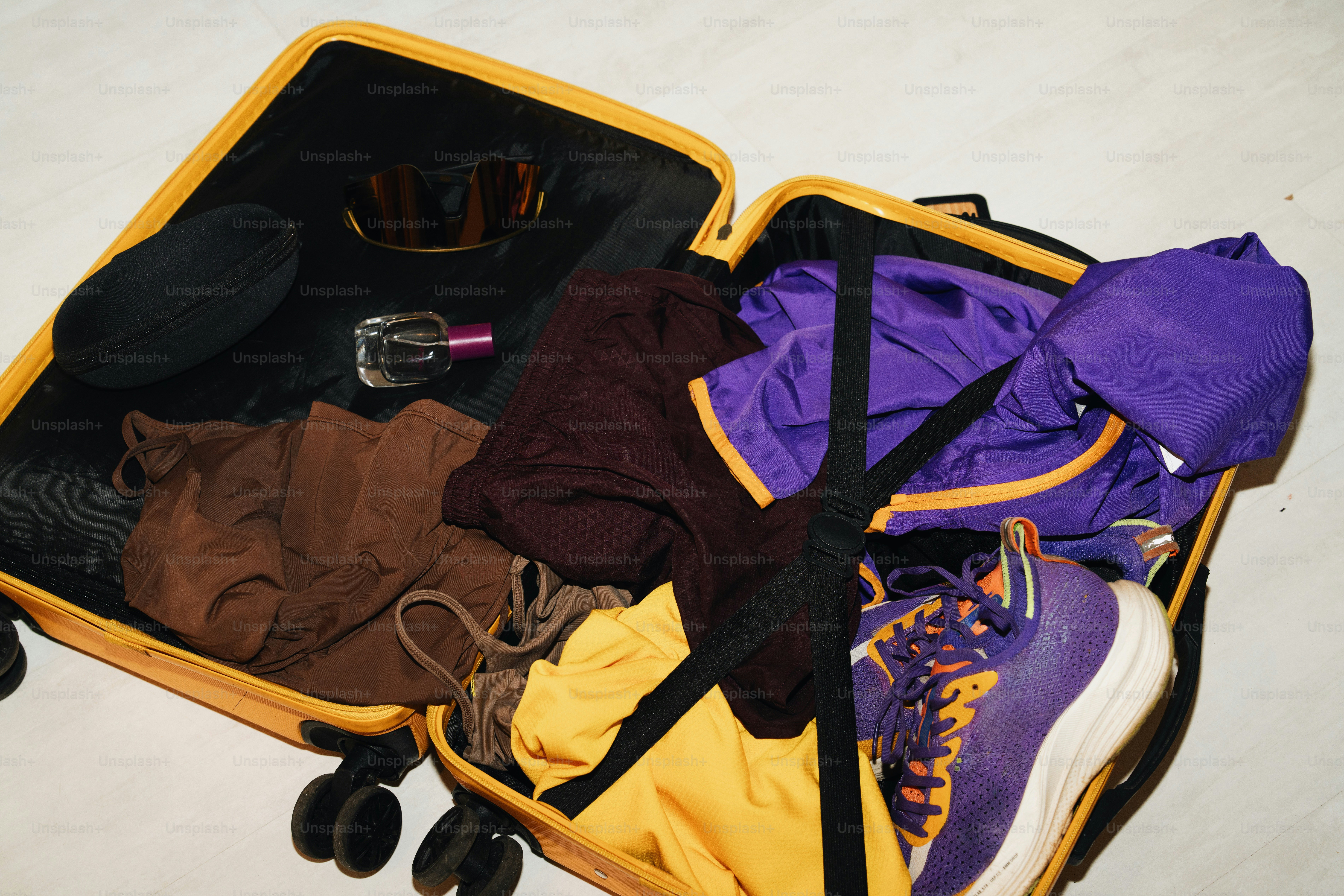 Open suitcase filled with clothes and shoes