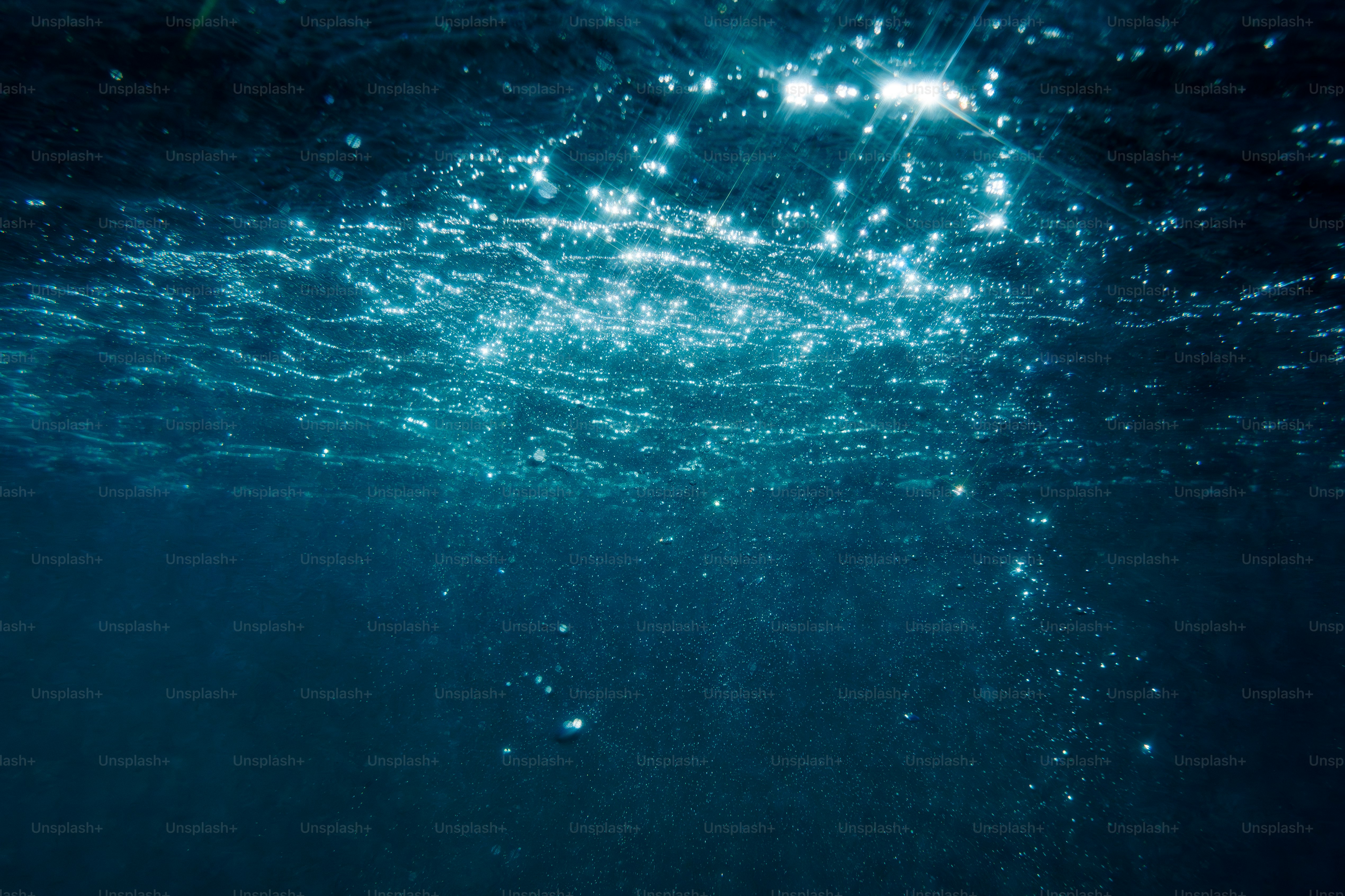 Sunlight filtering down through deep blue ocean water