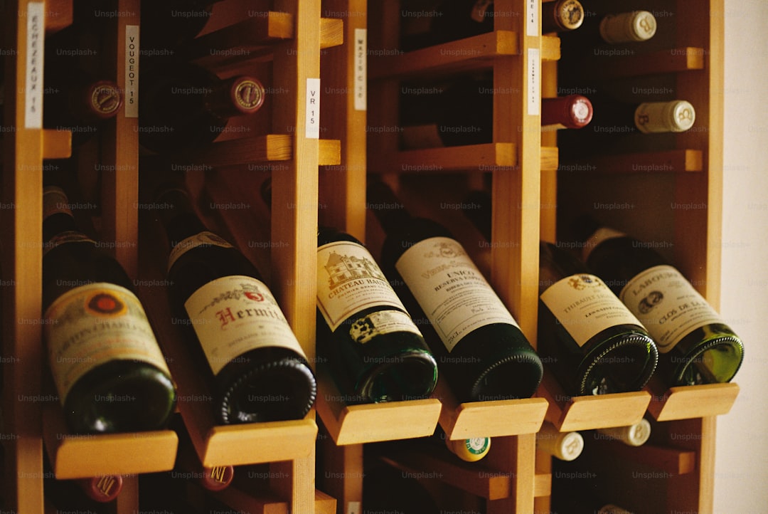 Wooden wine rack filled with assorted bottles