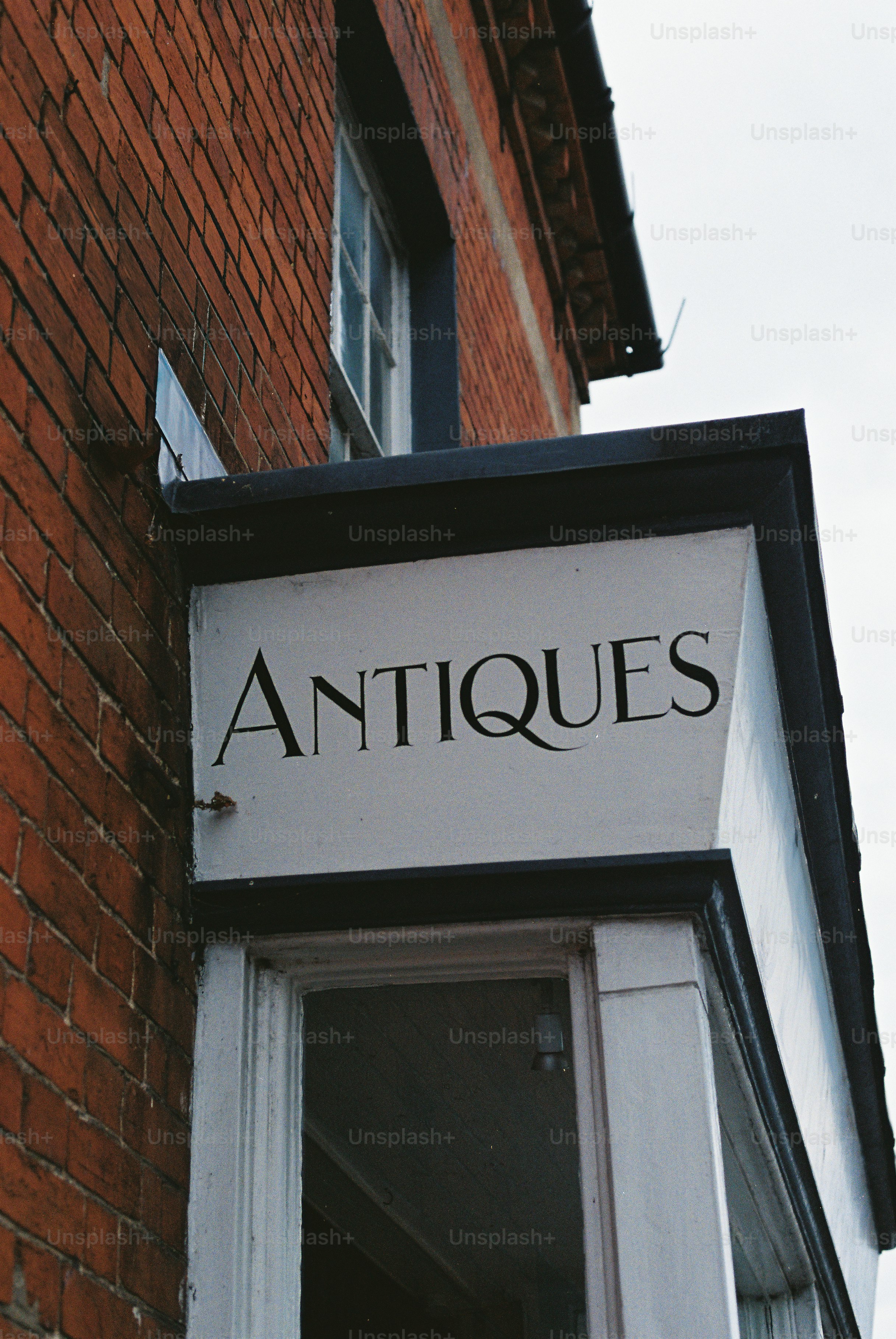 Un panneau pour une boutique d’antiquités sur un bâtiment en brique