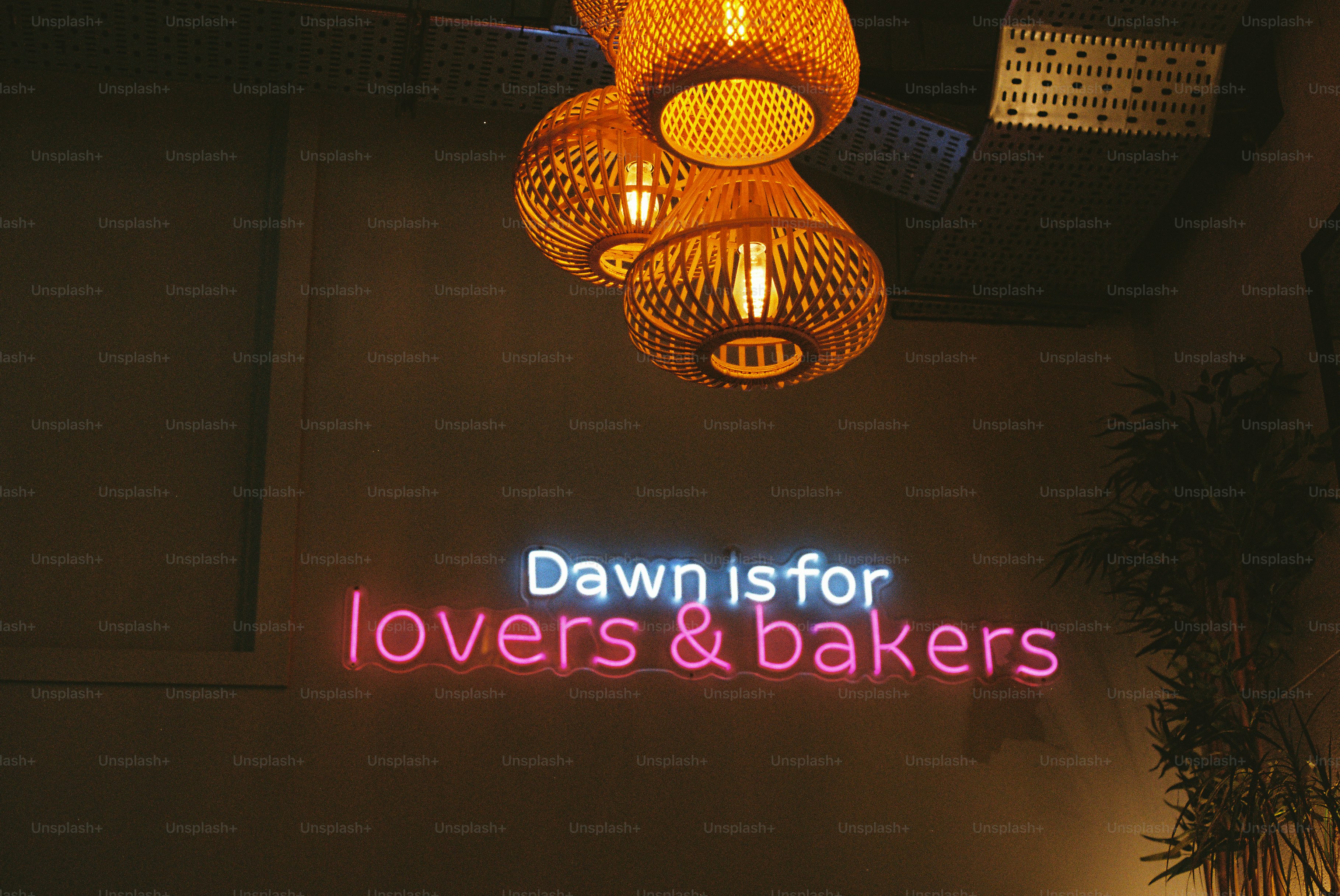 Neon sign reads "dawn is for lovers & bakers"