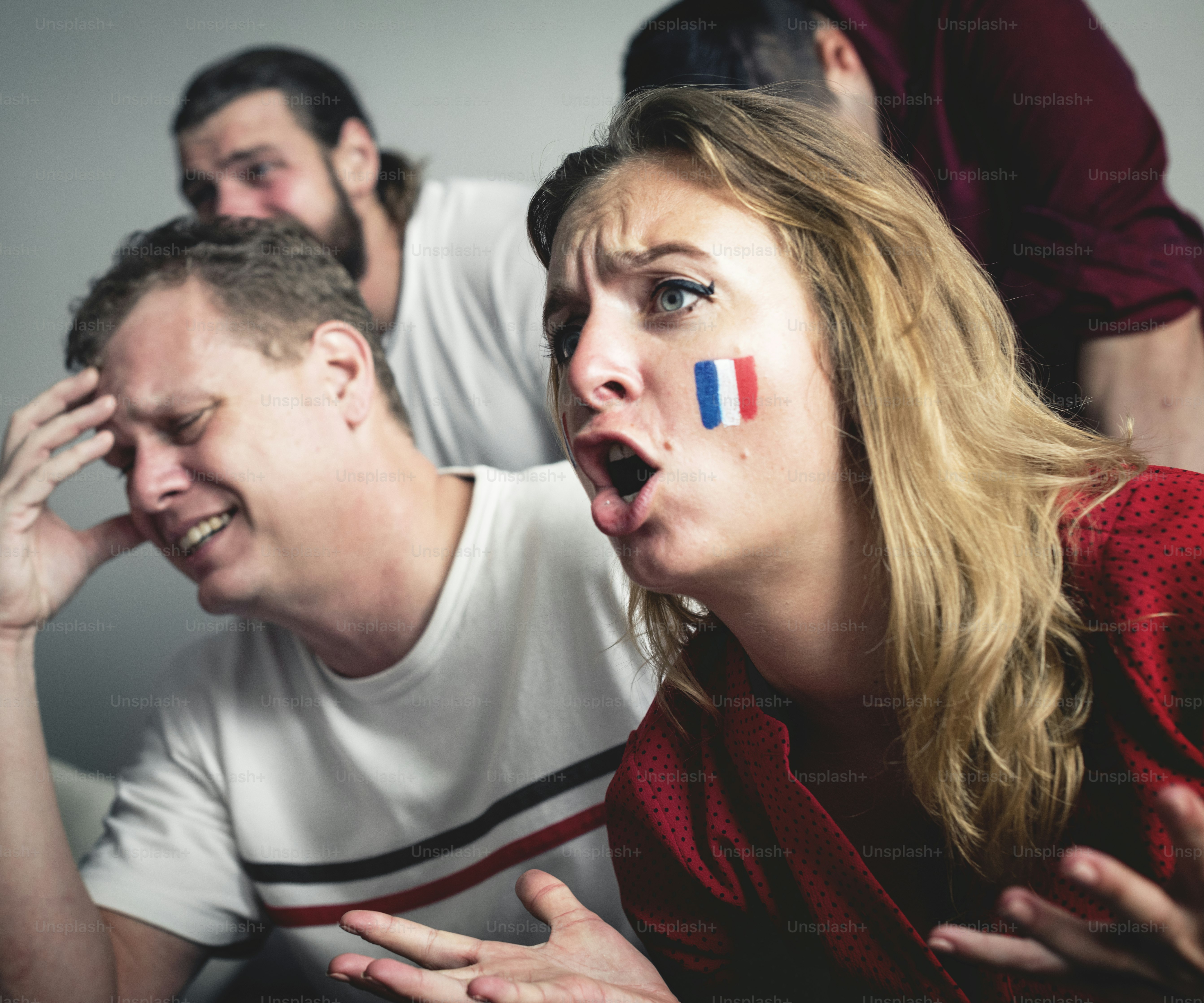 Friends cheering world cup with painted flag