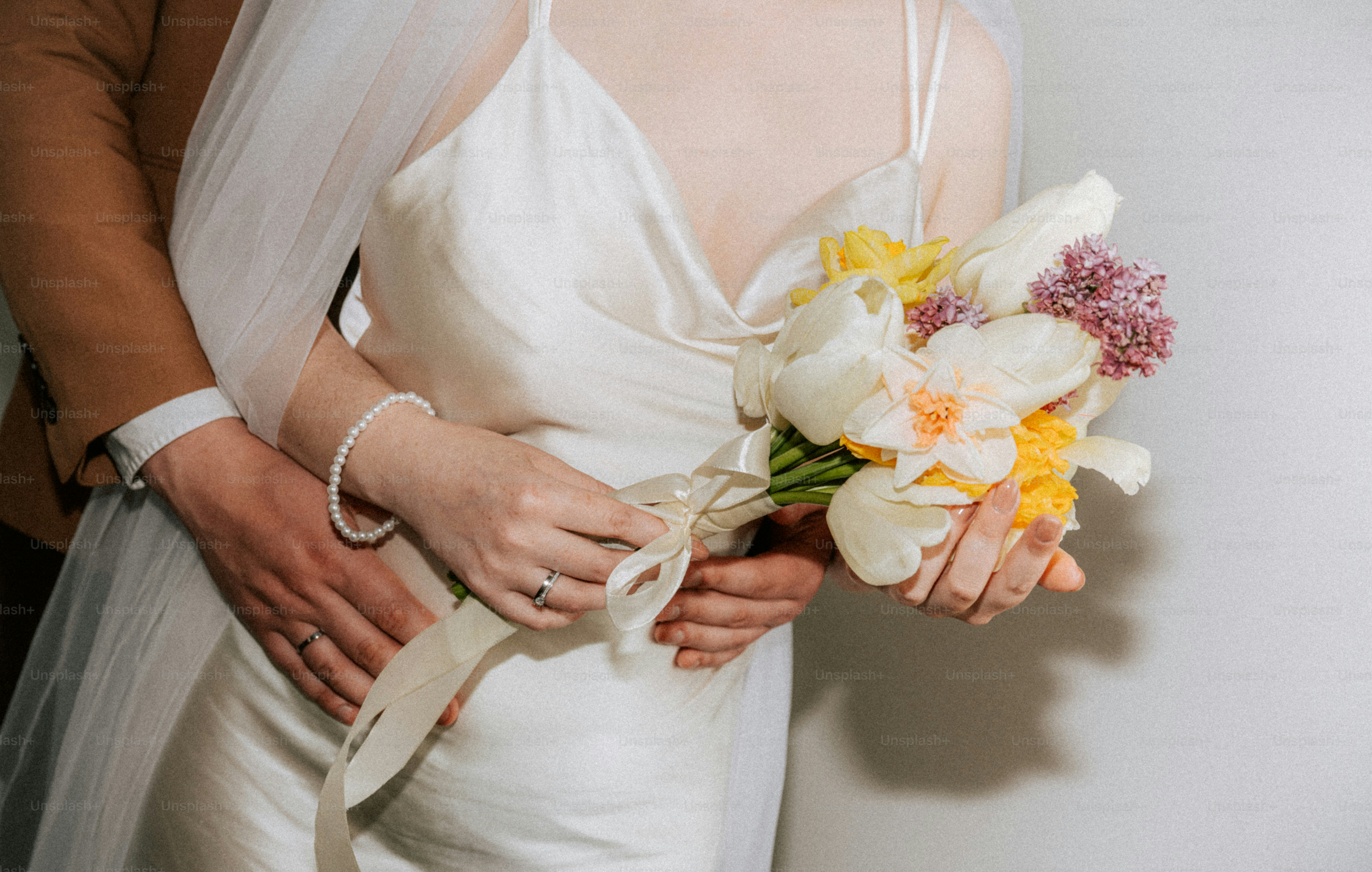 Bride and groom holding hands on grass photo – Flowers Image on Unsplash