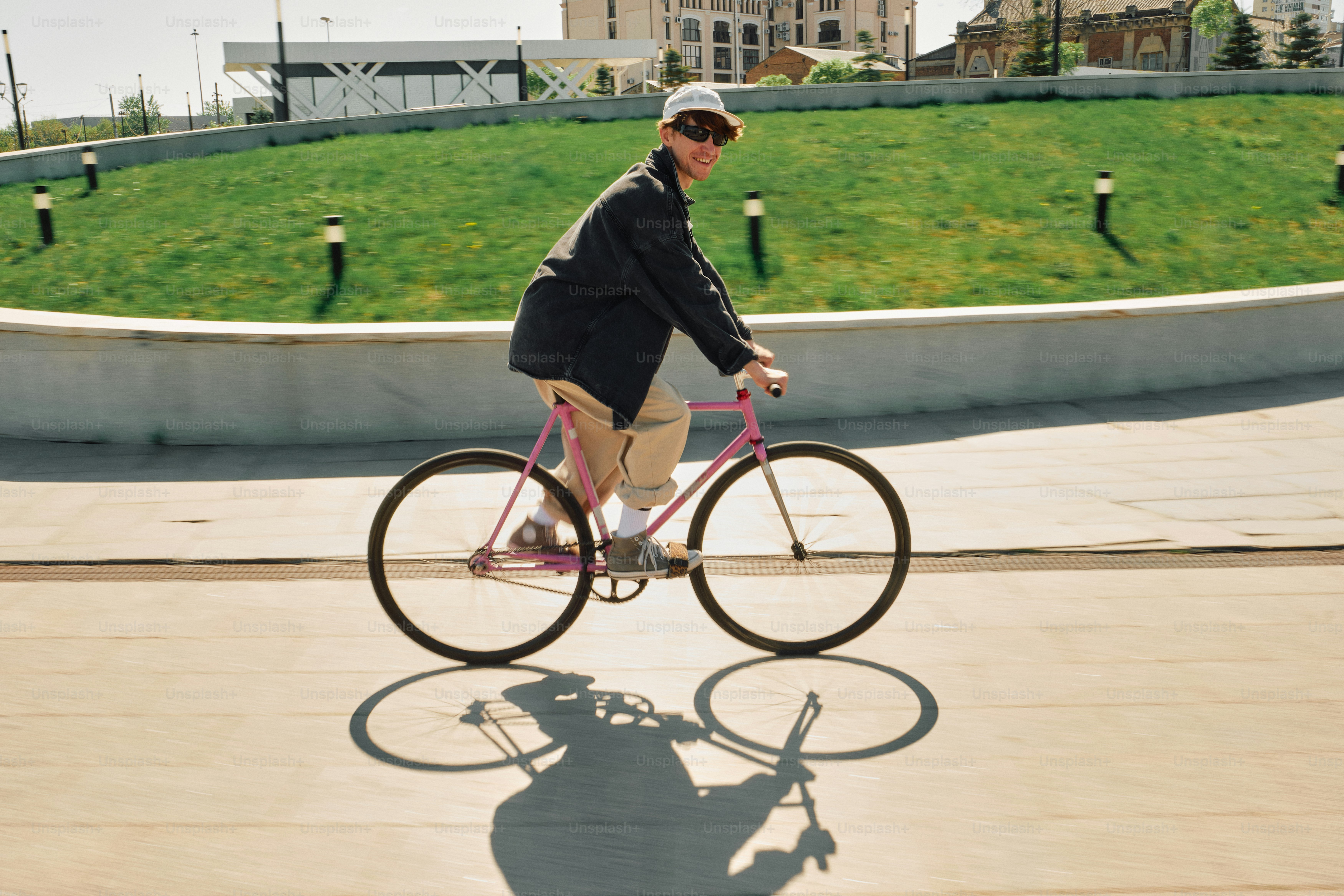 Person riding a bicycle in front of a wooden wall photo – City Image on ...