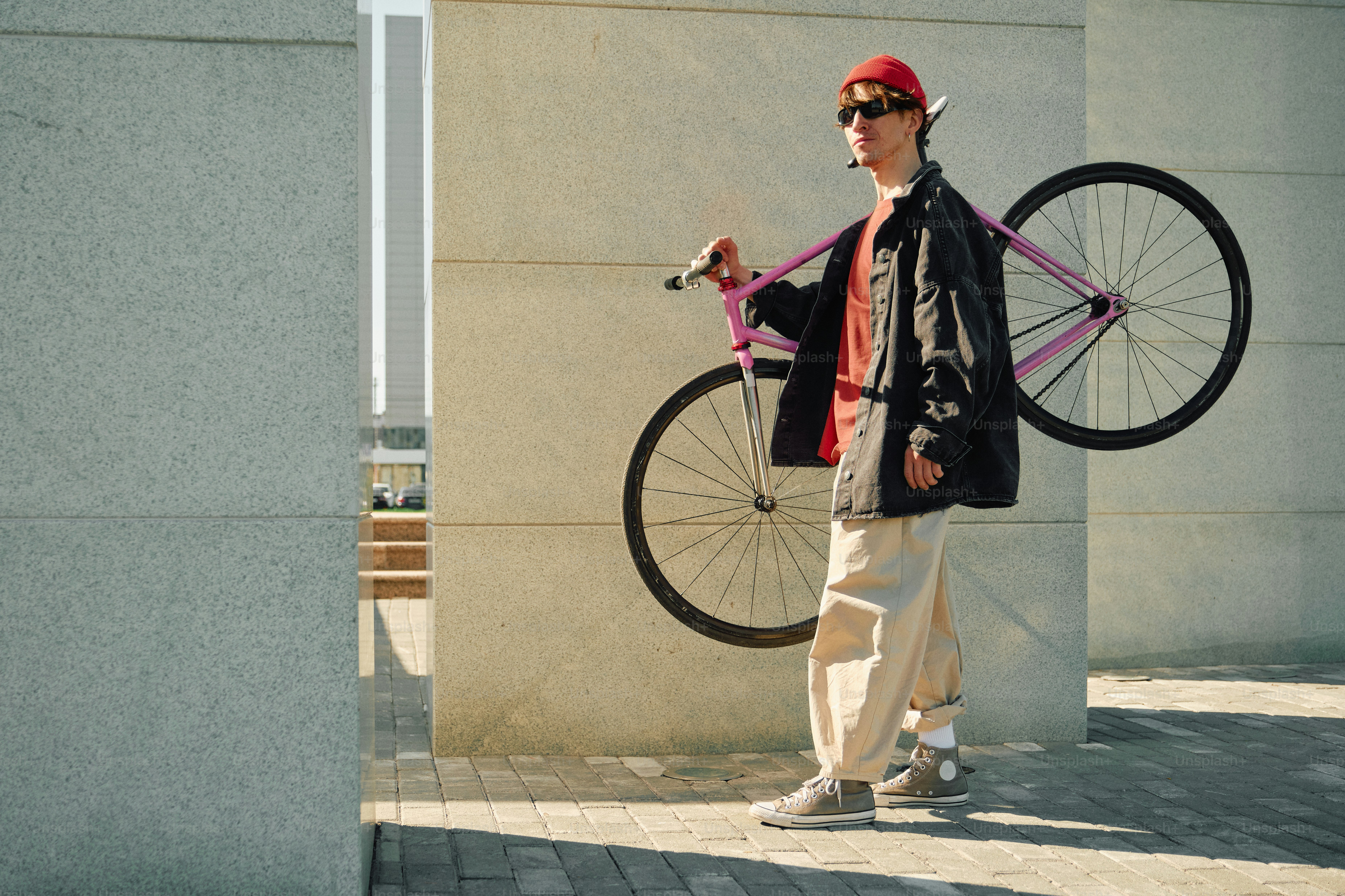 Person riding a bicycle in front of a wooden wall photo – City Image on ...