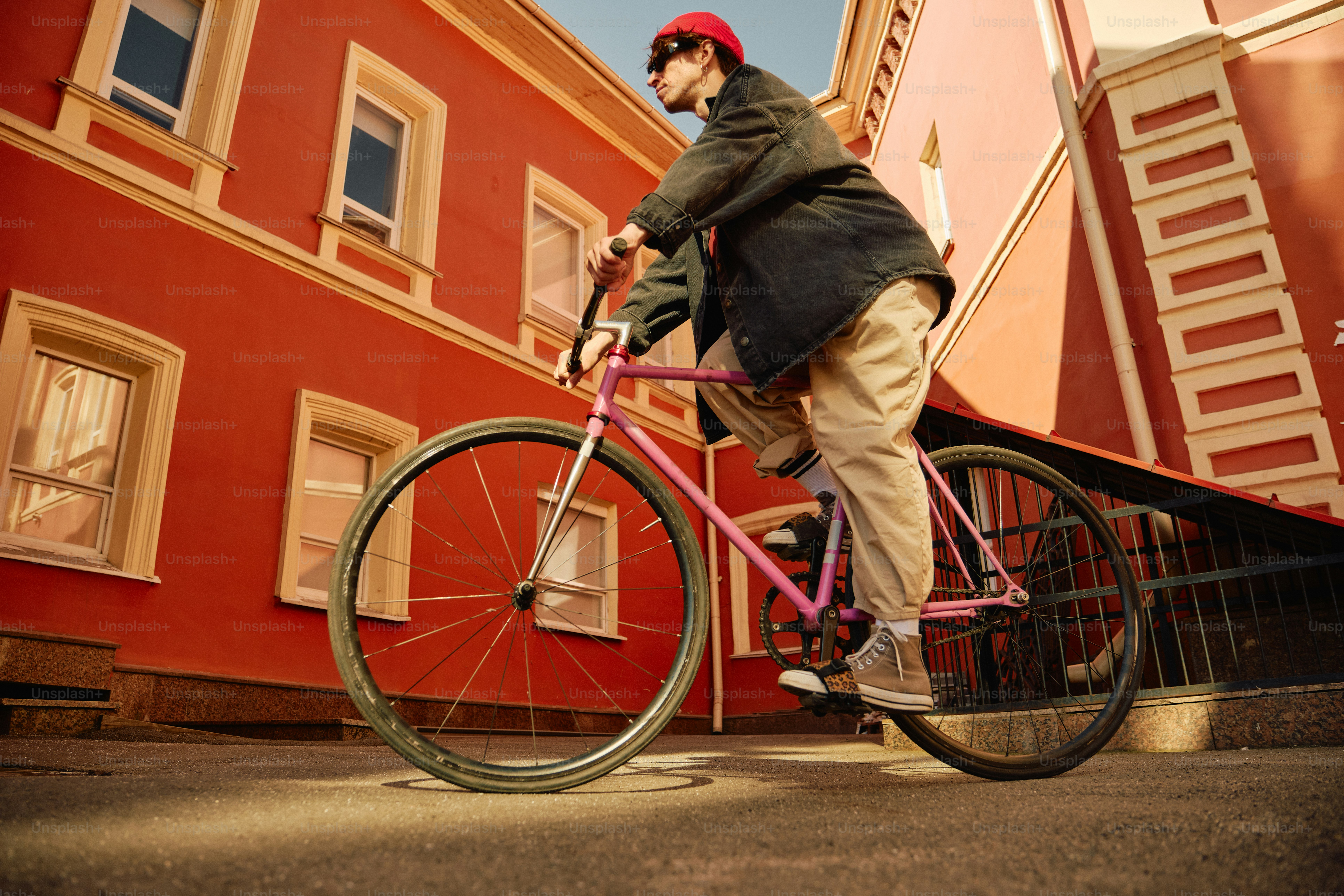 A person rides a bicycle down a street.