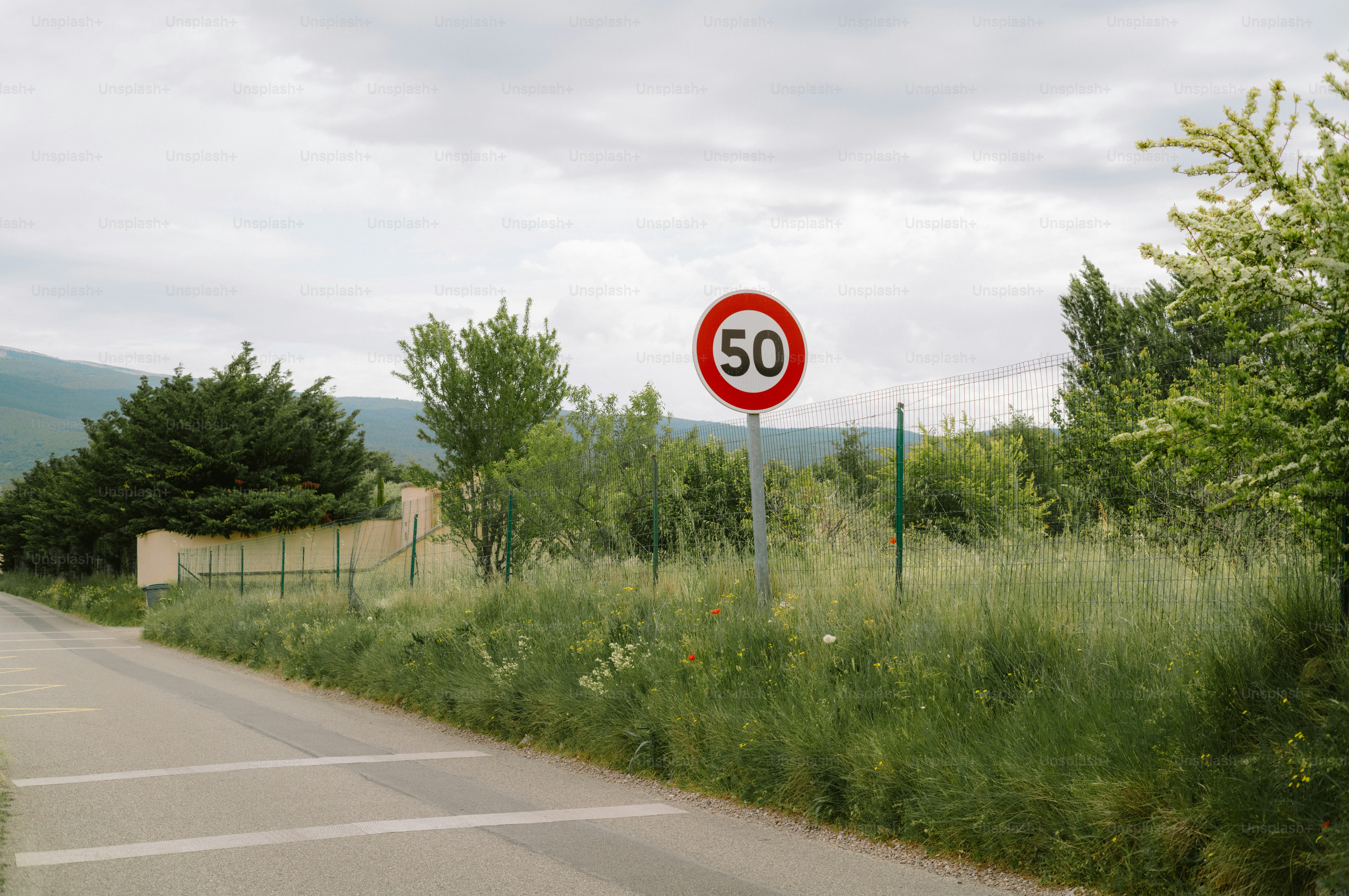 Speed limit sign showing 50 on a road.