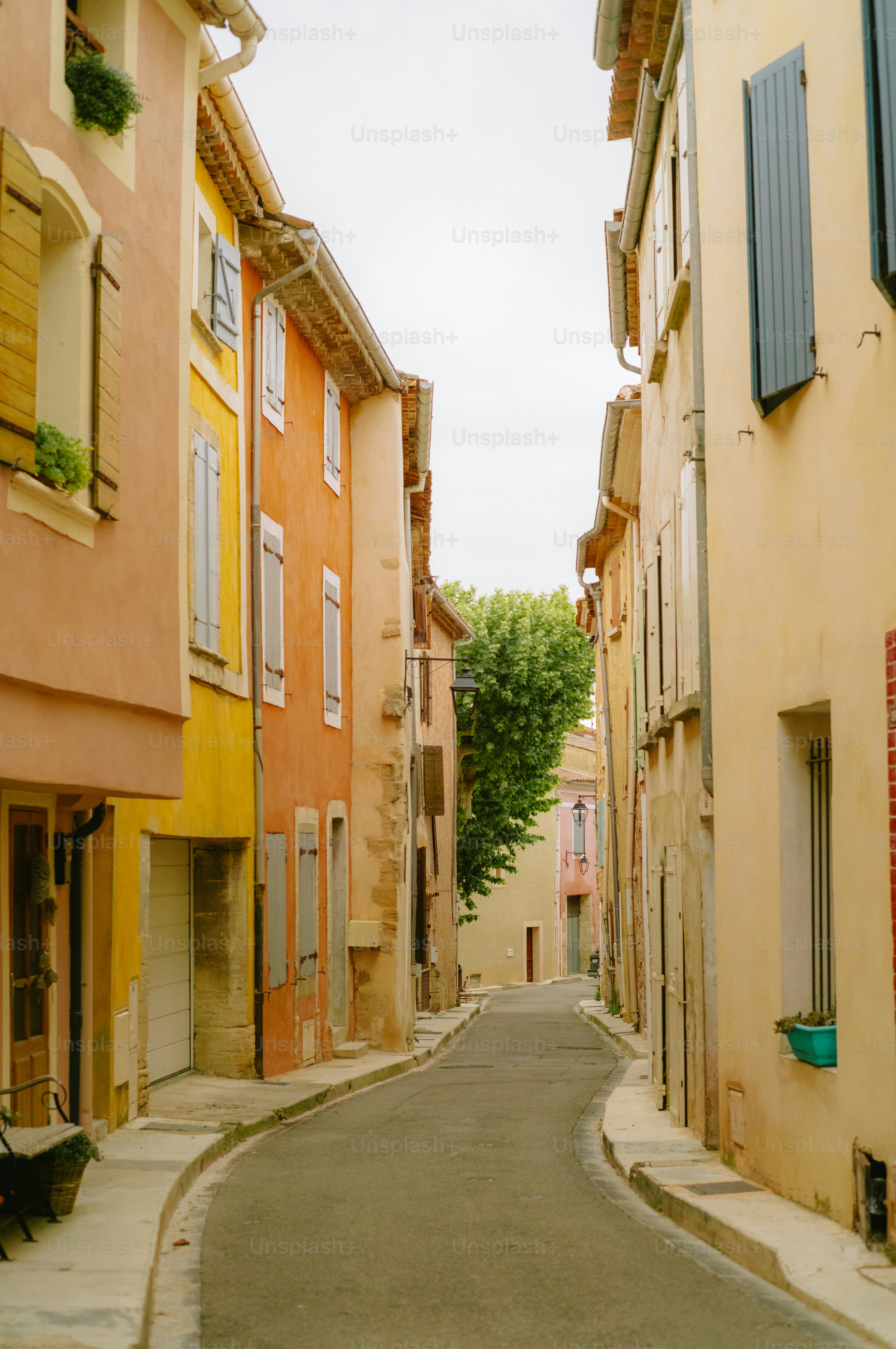 Narrow street lined with colorful buildings in a village.