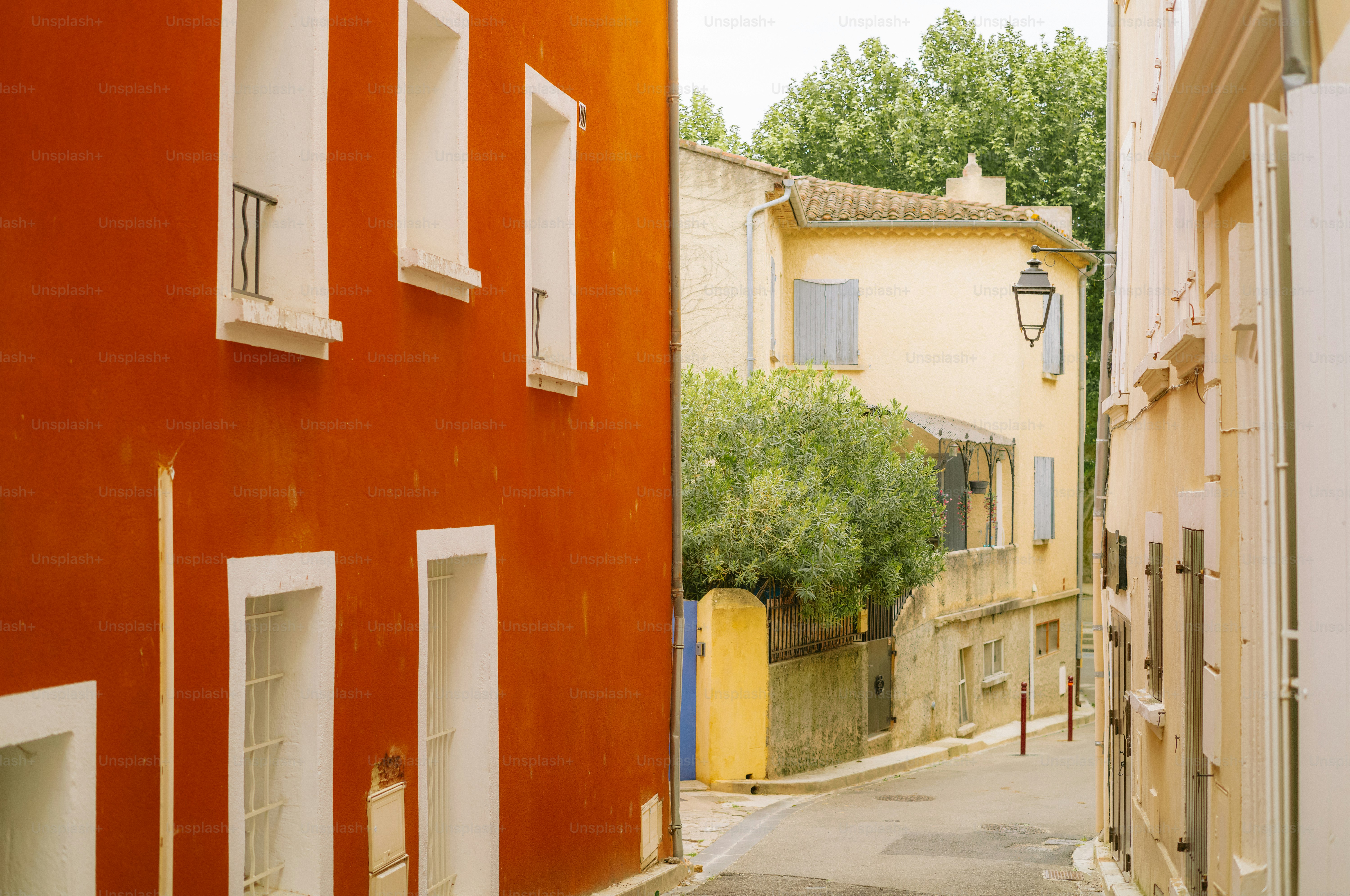 Narrow street with colorful buildings and trees.