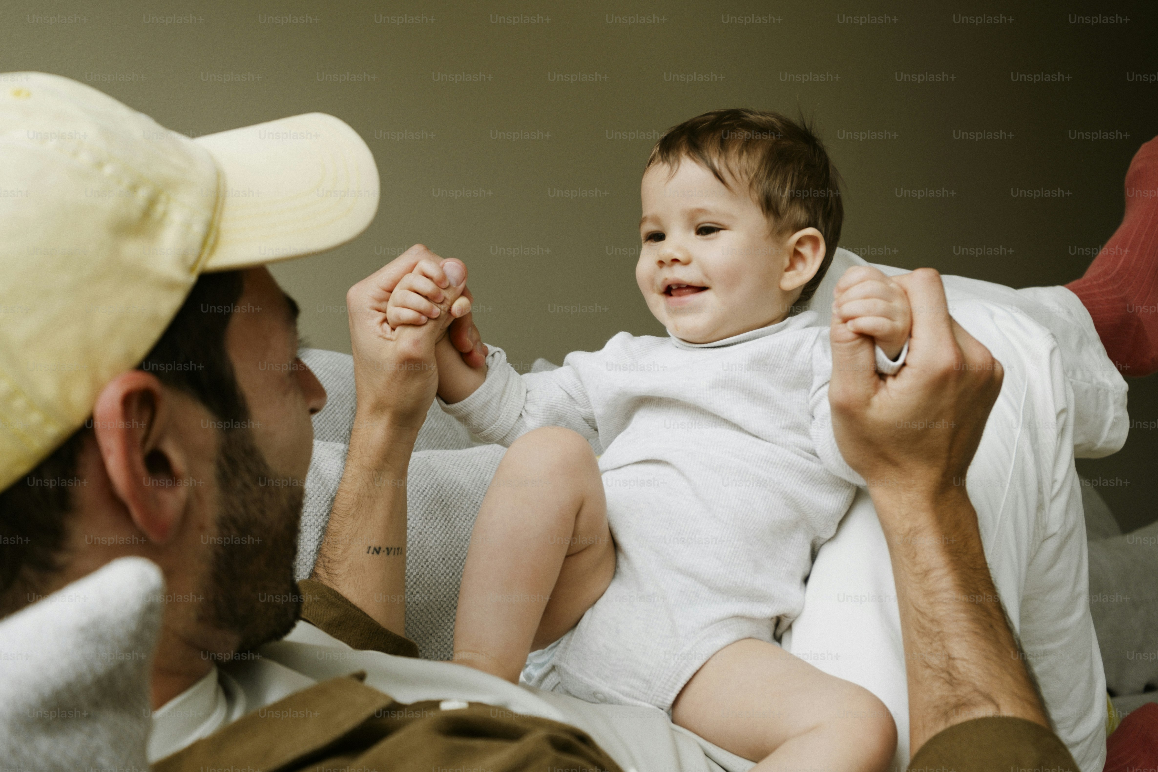 Father and baby playing together on a couch