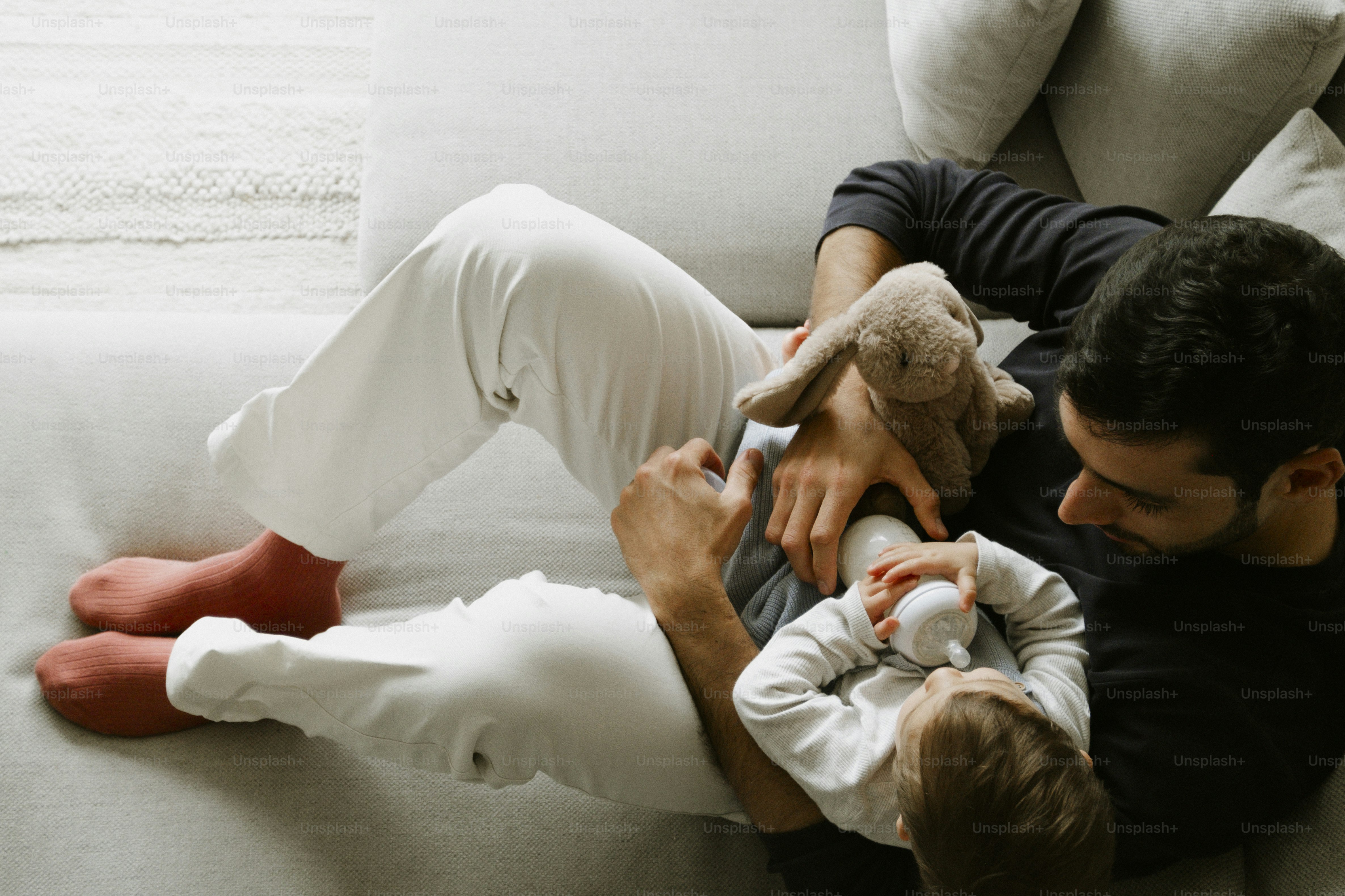 Father and baby bonding on a couch