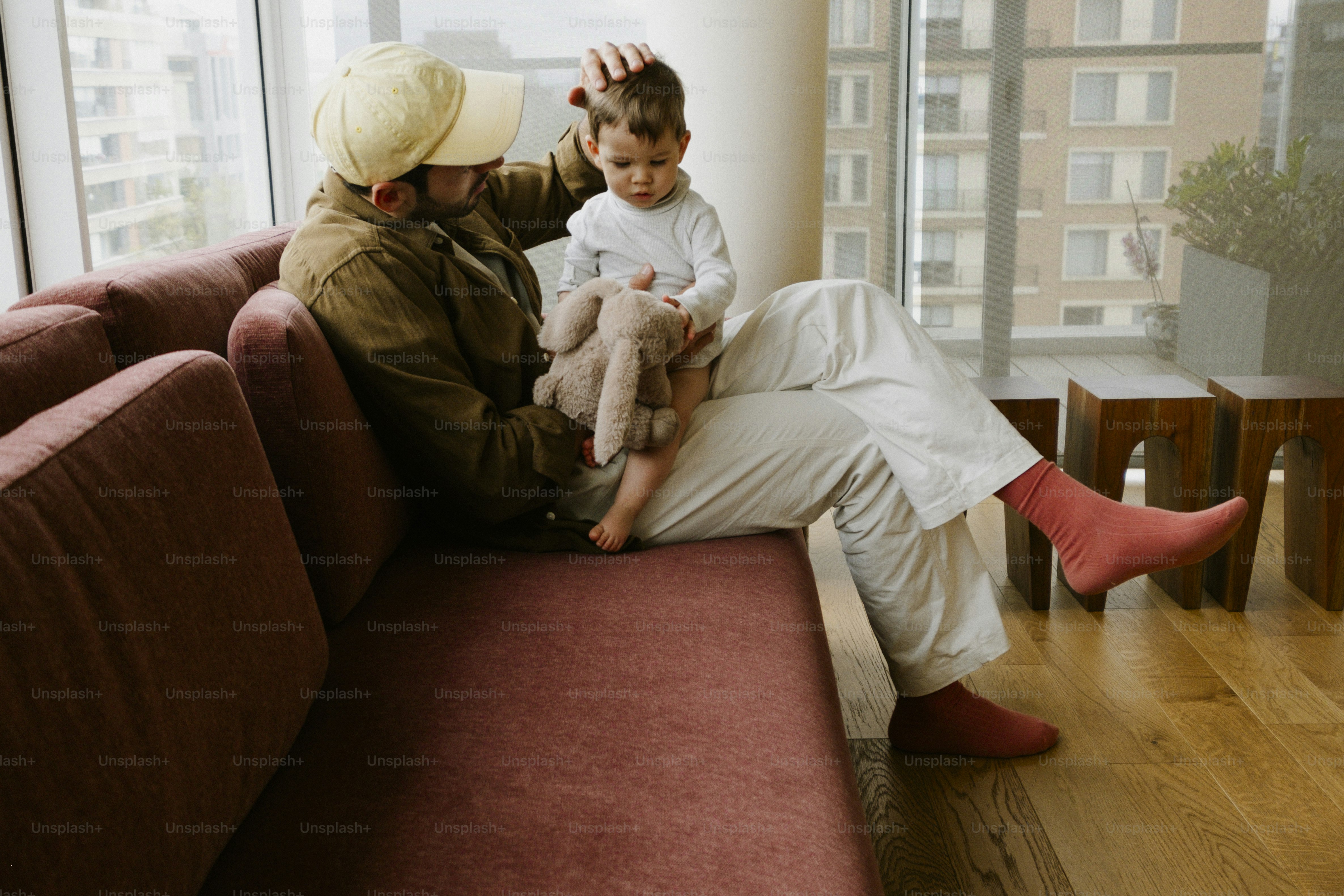 Man with child and toy on sofa