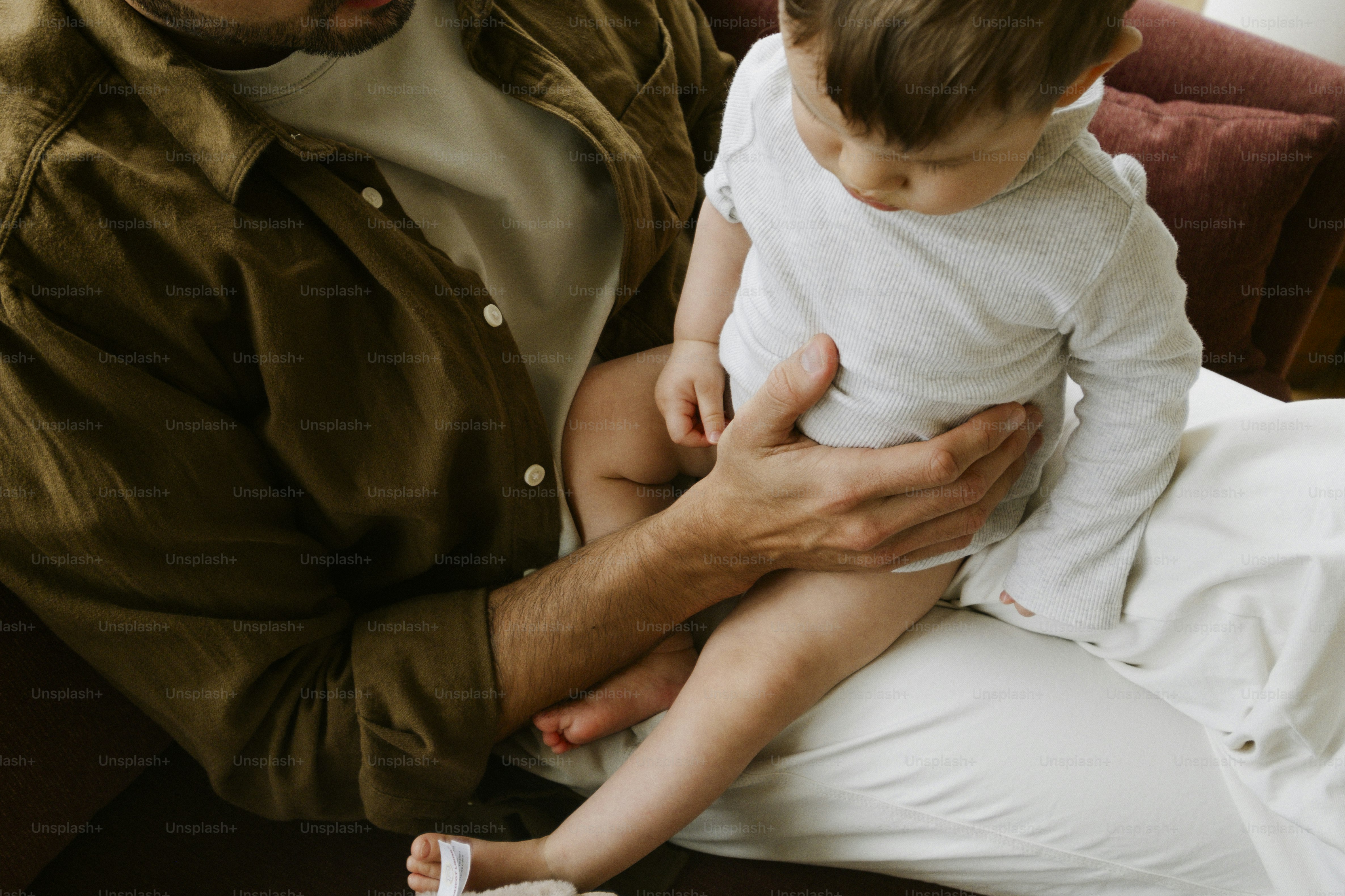 Adult holding a baby on their lap