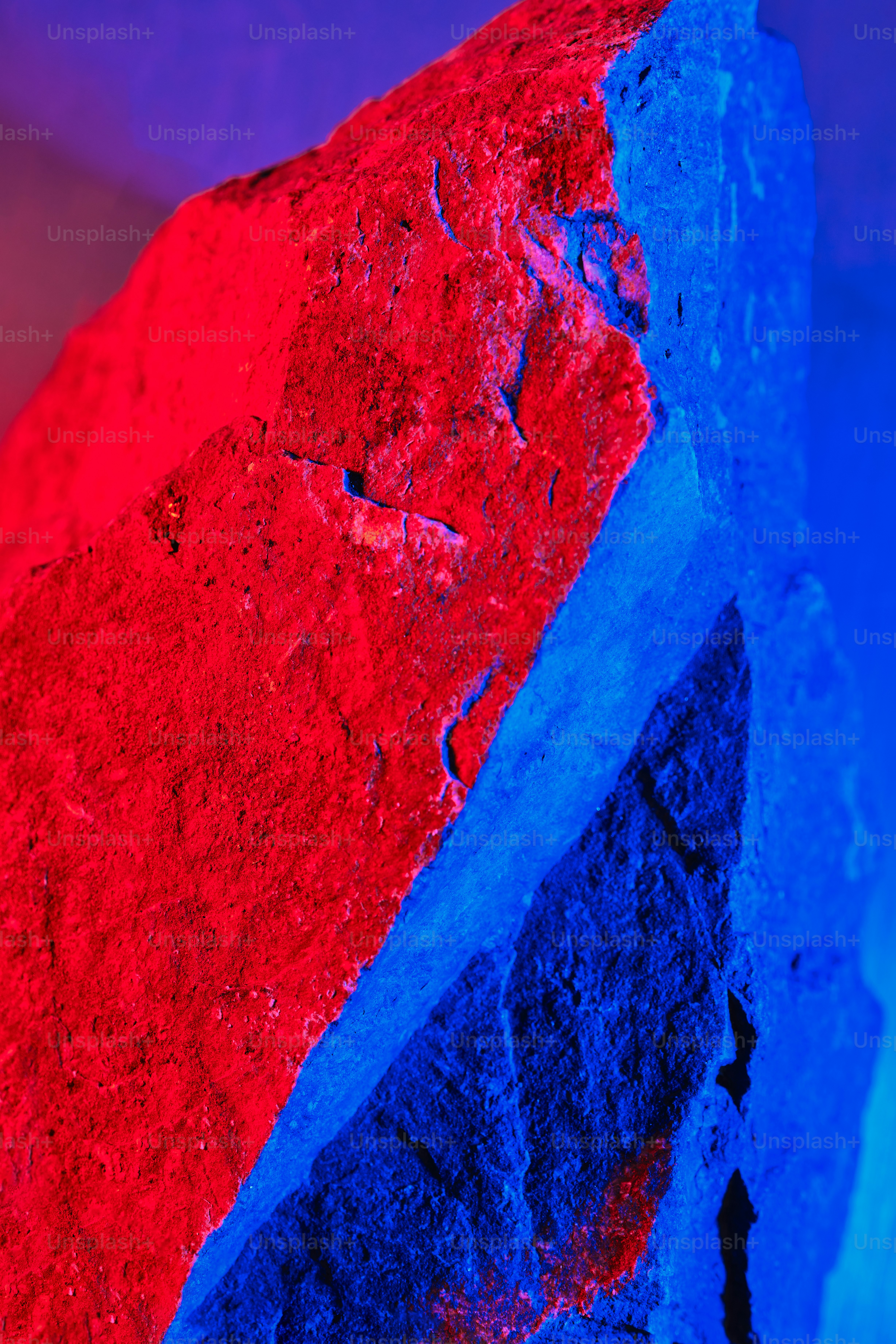 A rough rock illuminated with red and blue light. photo – Texture Image ...