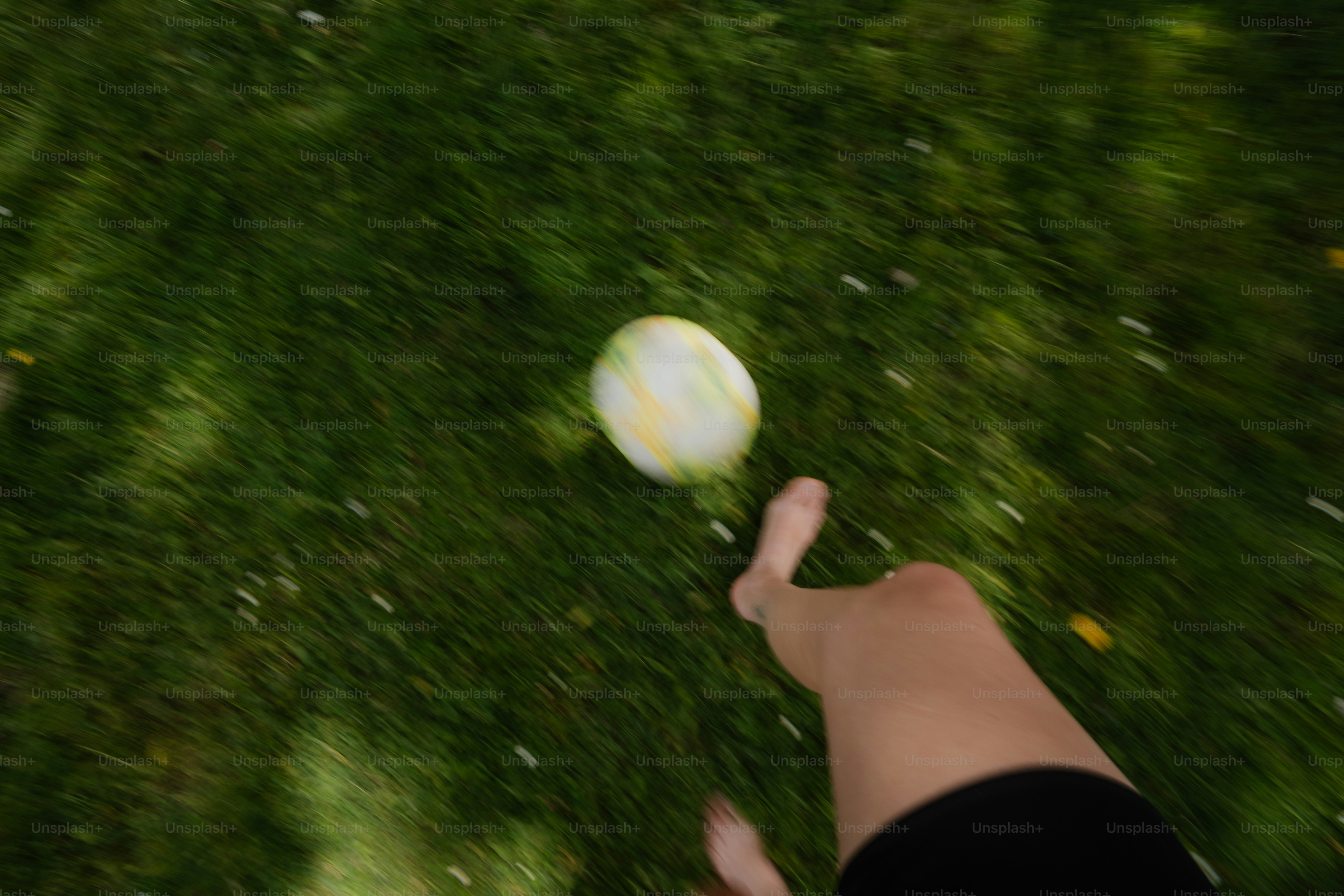 Um pé alcançando uma bola na grama