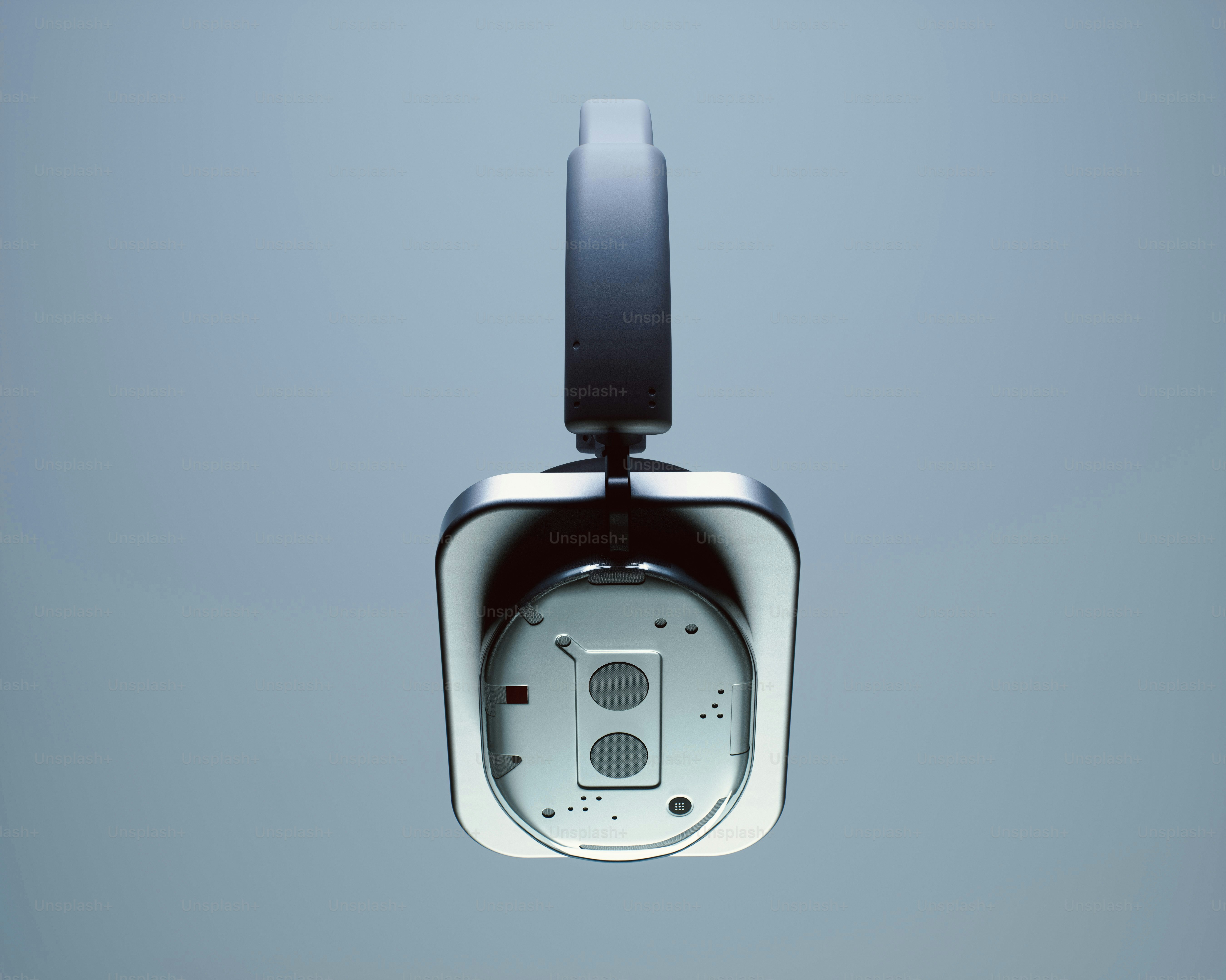 A single modern headphone against a light blue background.