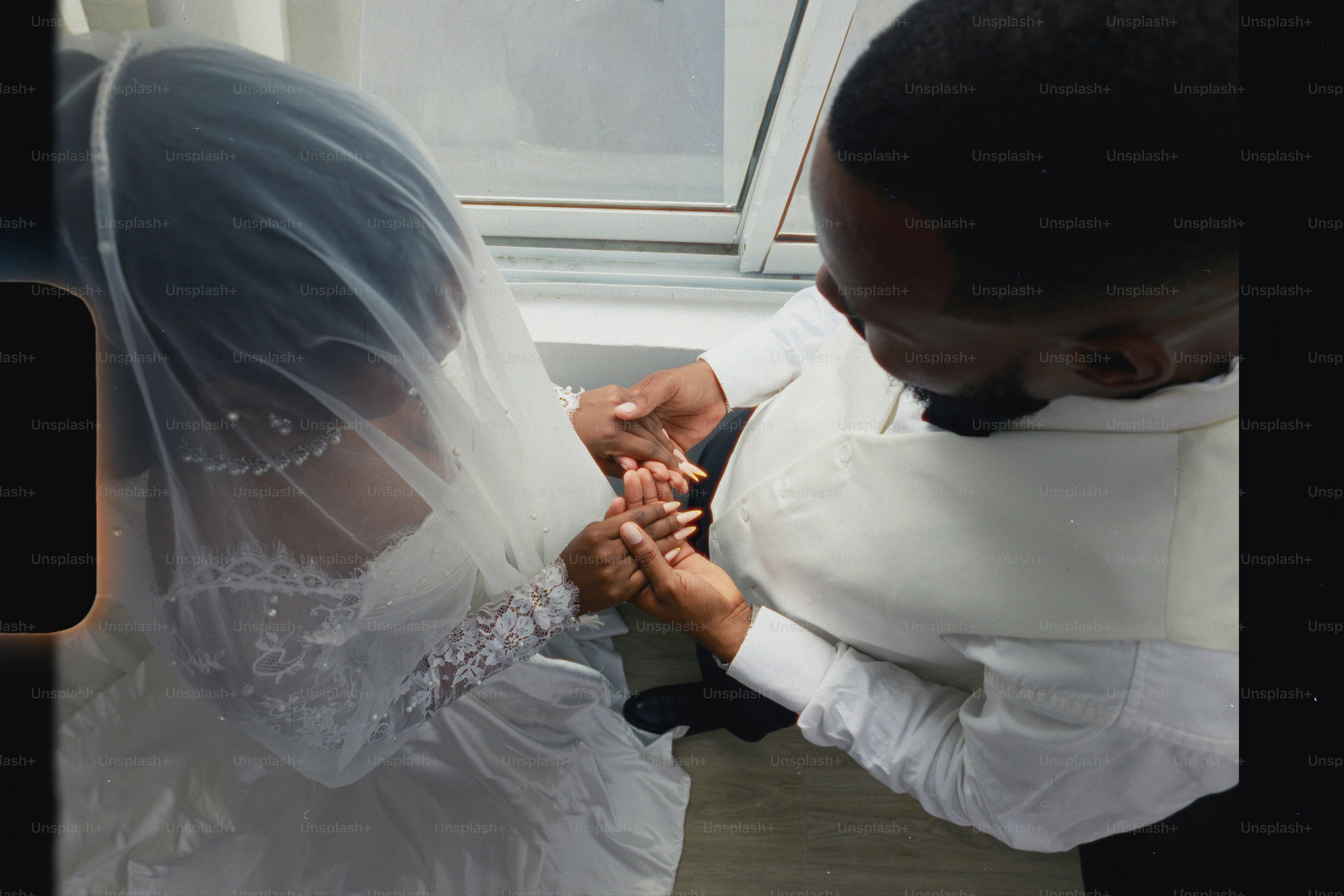 Bride and groom holding hands during wedding ceremony.