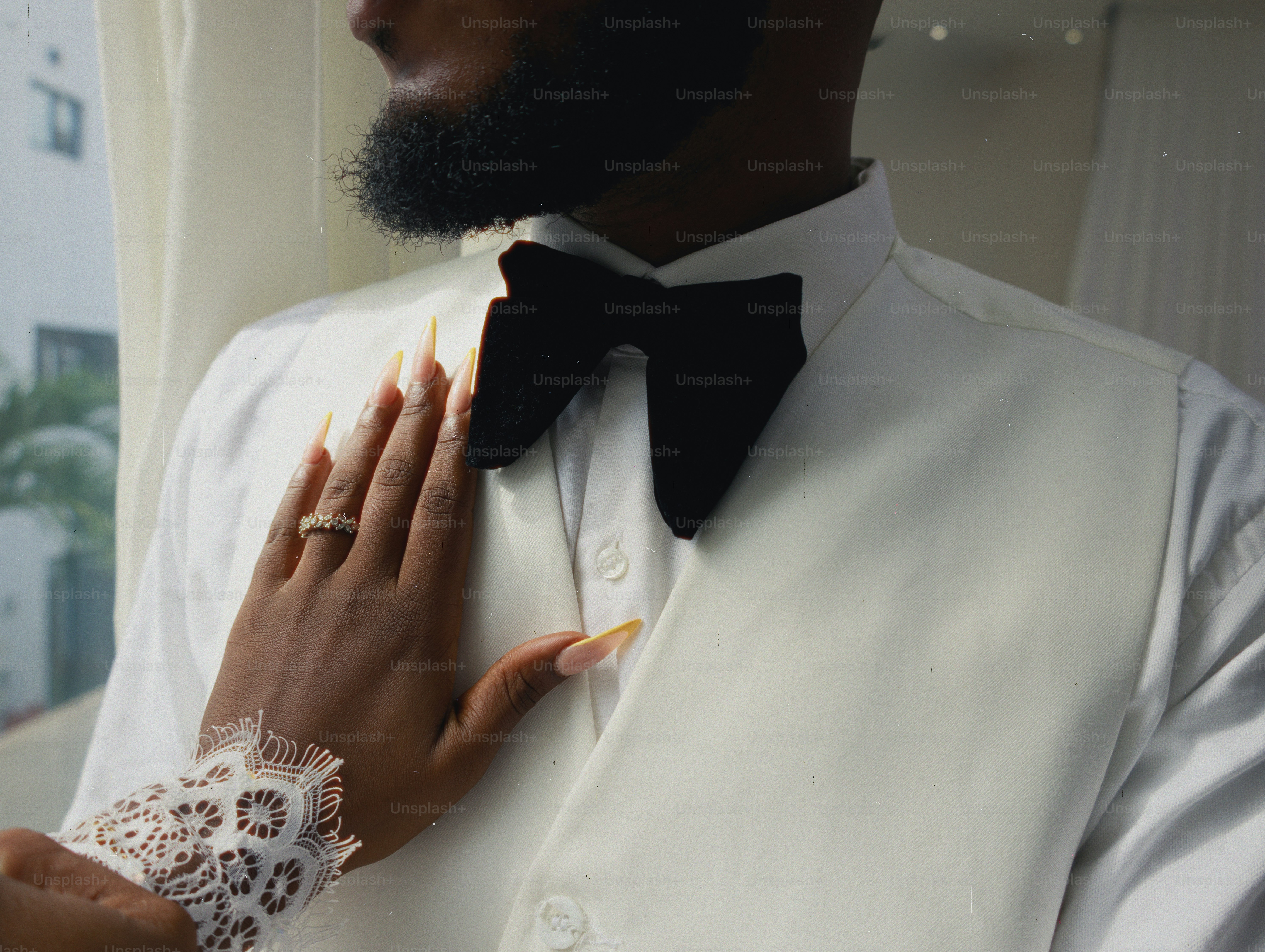 A bride's hand rests on groom's chest