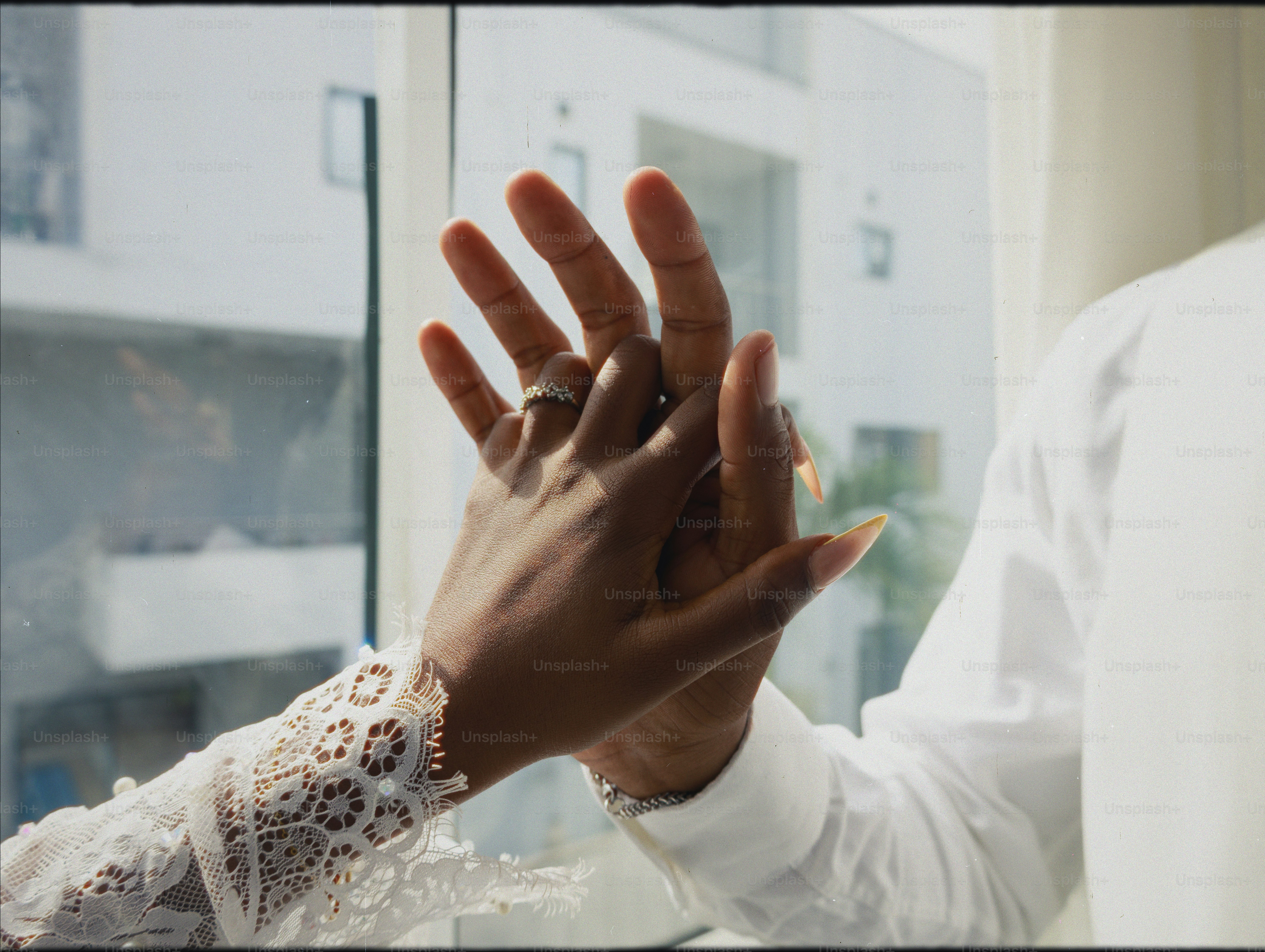 Couple holding hands with wedding ring visible