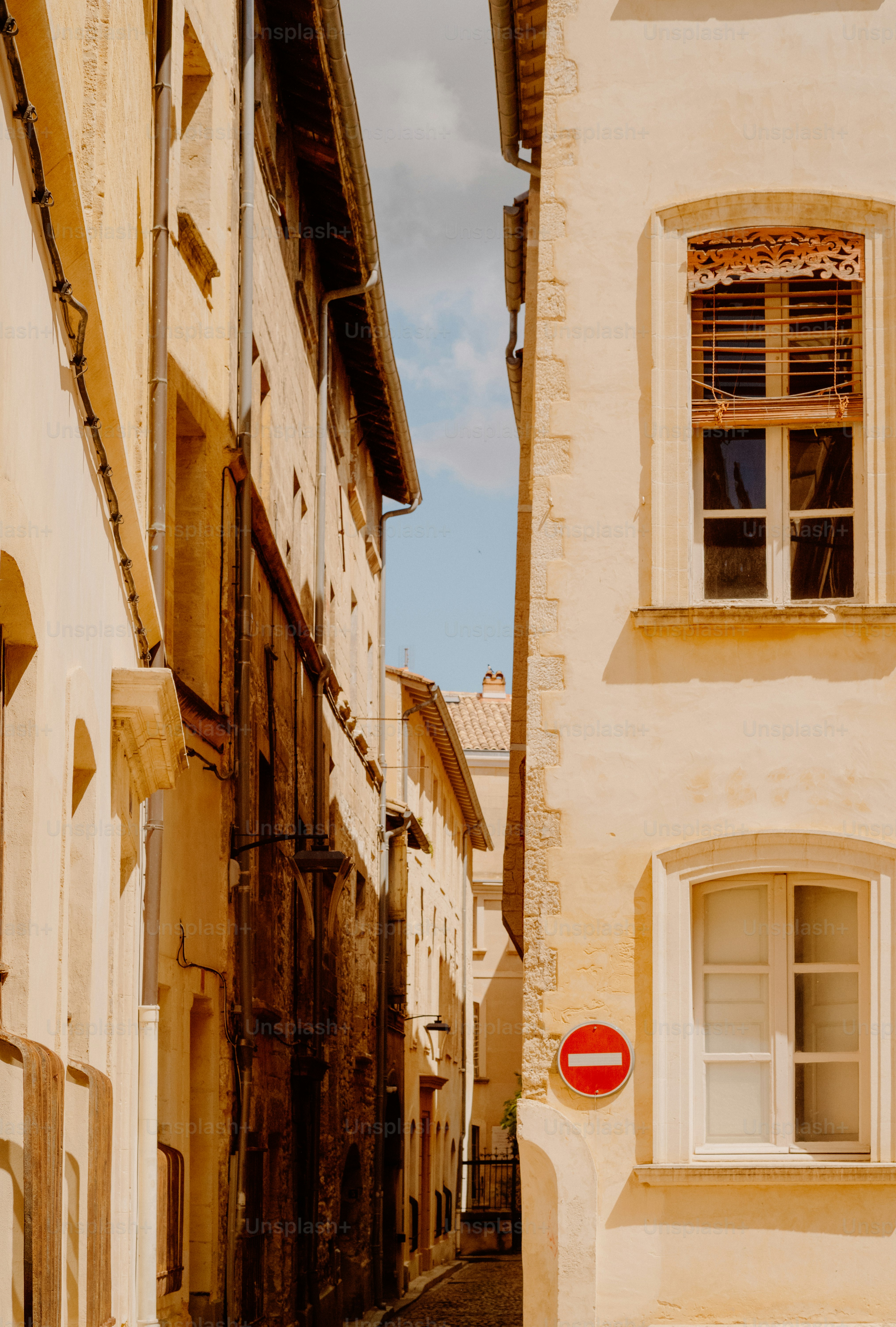 Narrow street between old buildings with a no entry sign.