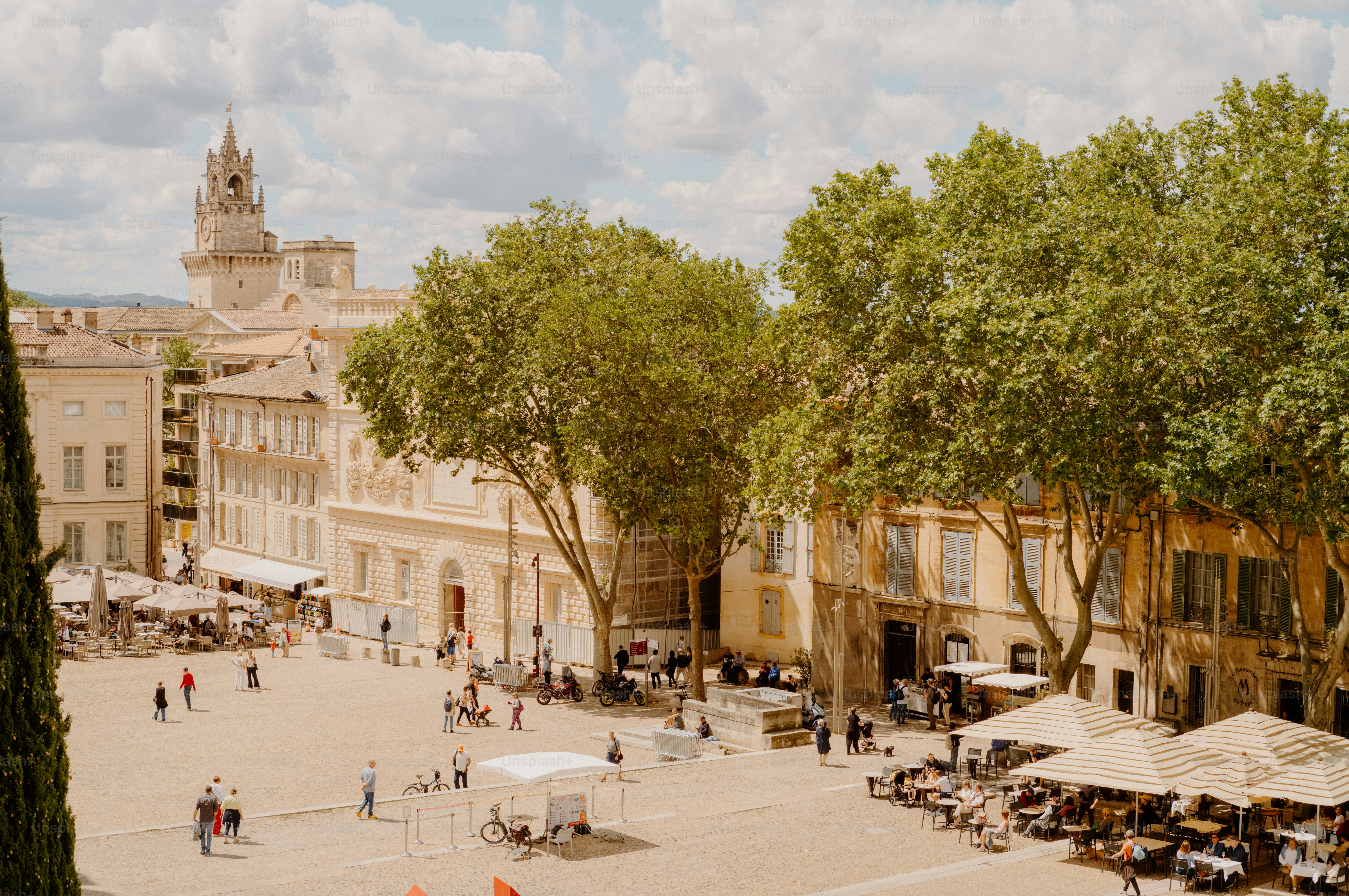 People gather in a sunny european town square.