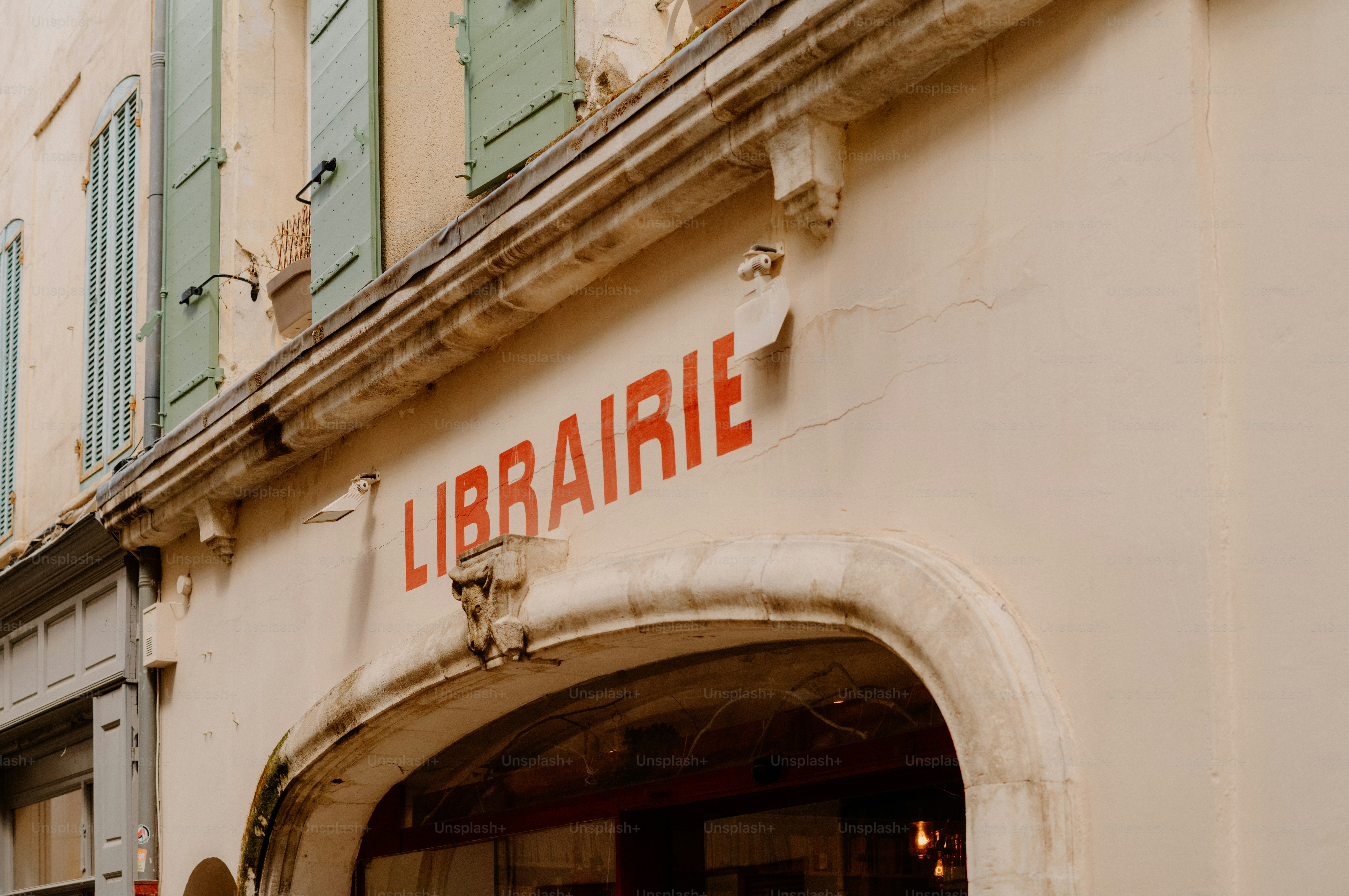 Red lettering spells librairie above an archway.