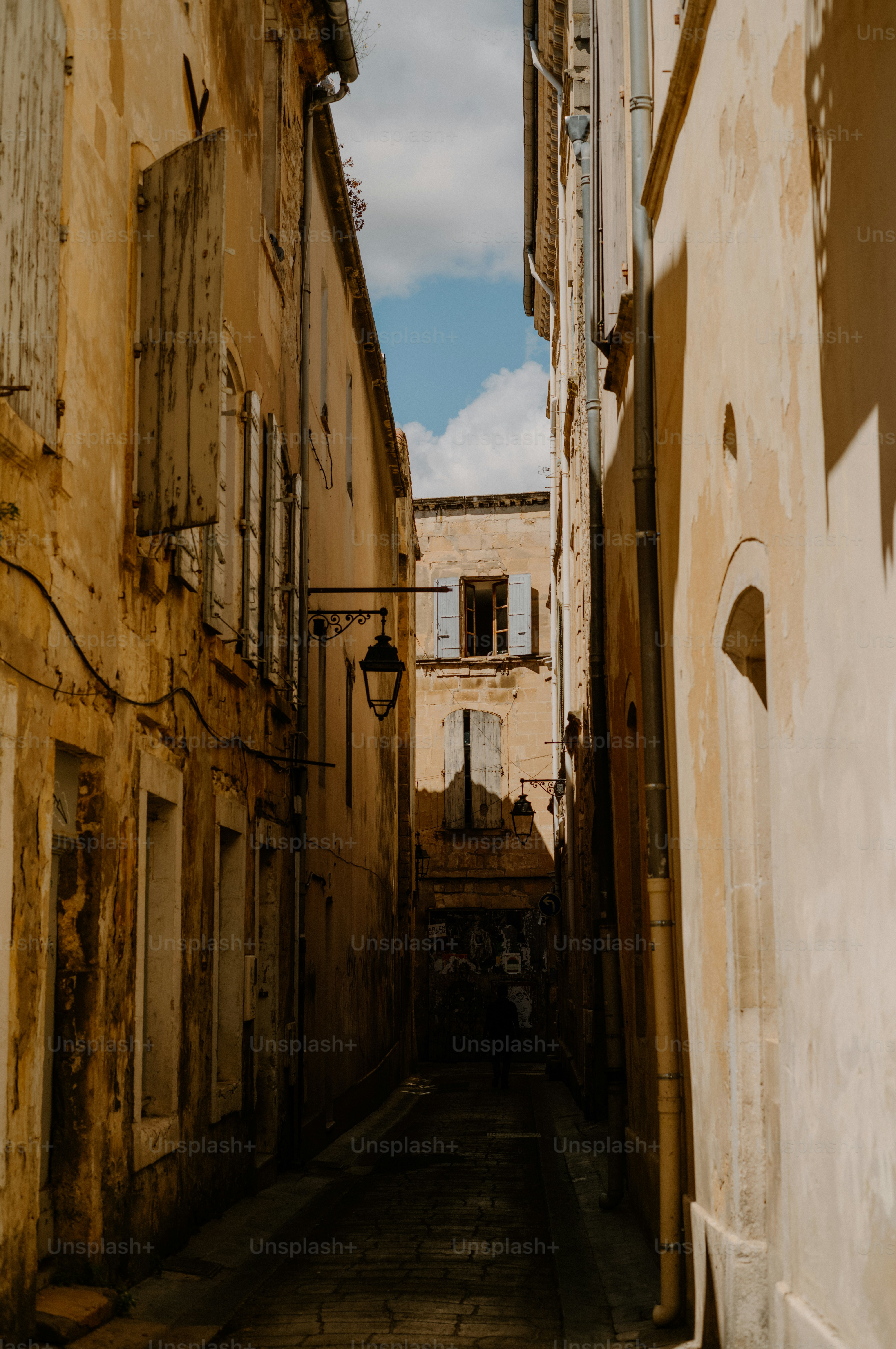 Narrow european street with old buildings and shutters