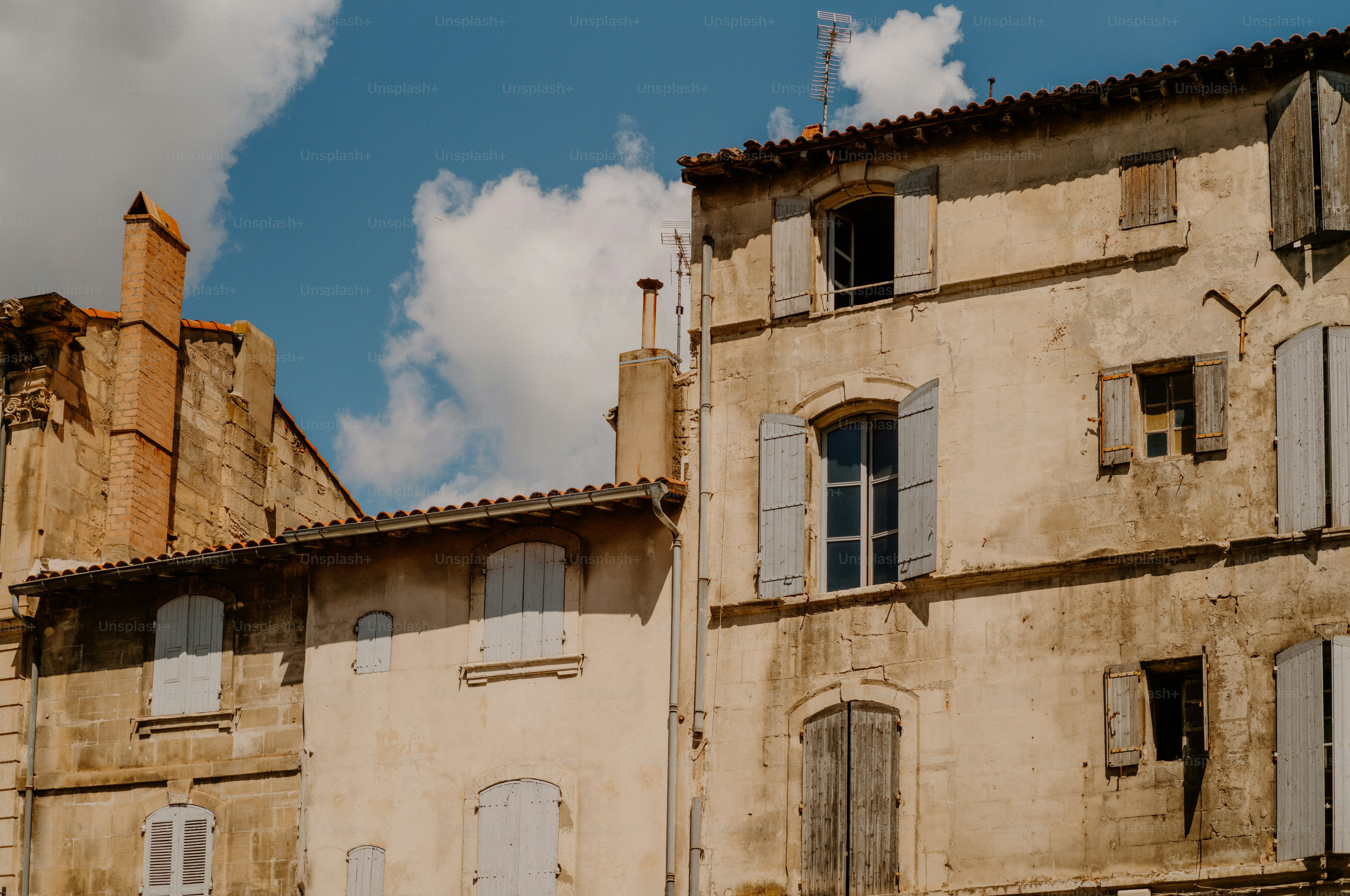 Old buildings with shutters under a blue sky