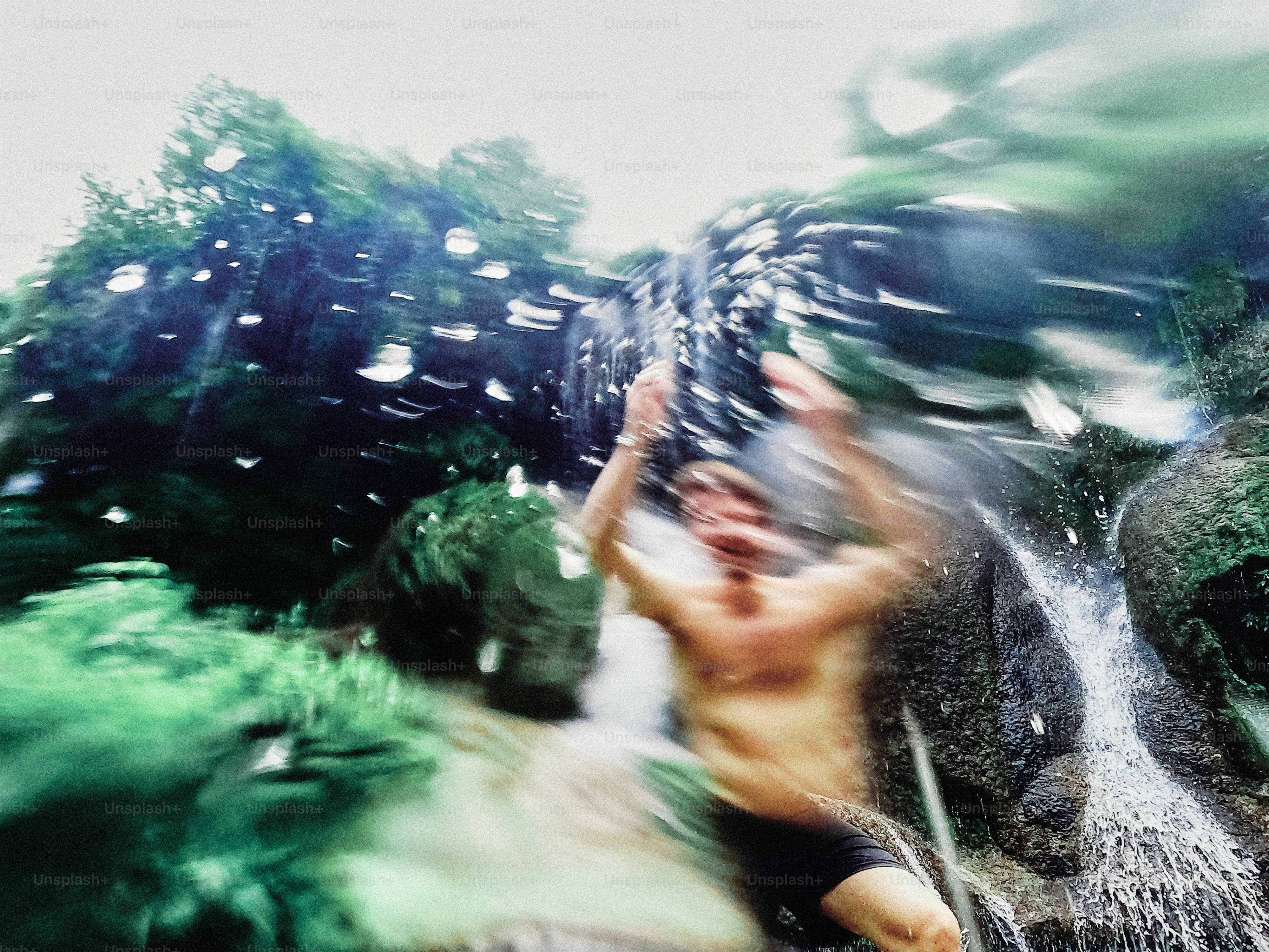 Man falling into a waterfall with motion blur effect photo – Travel ...