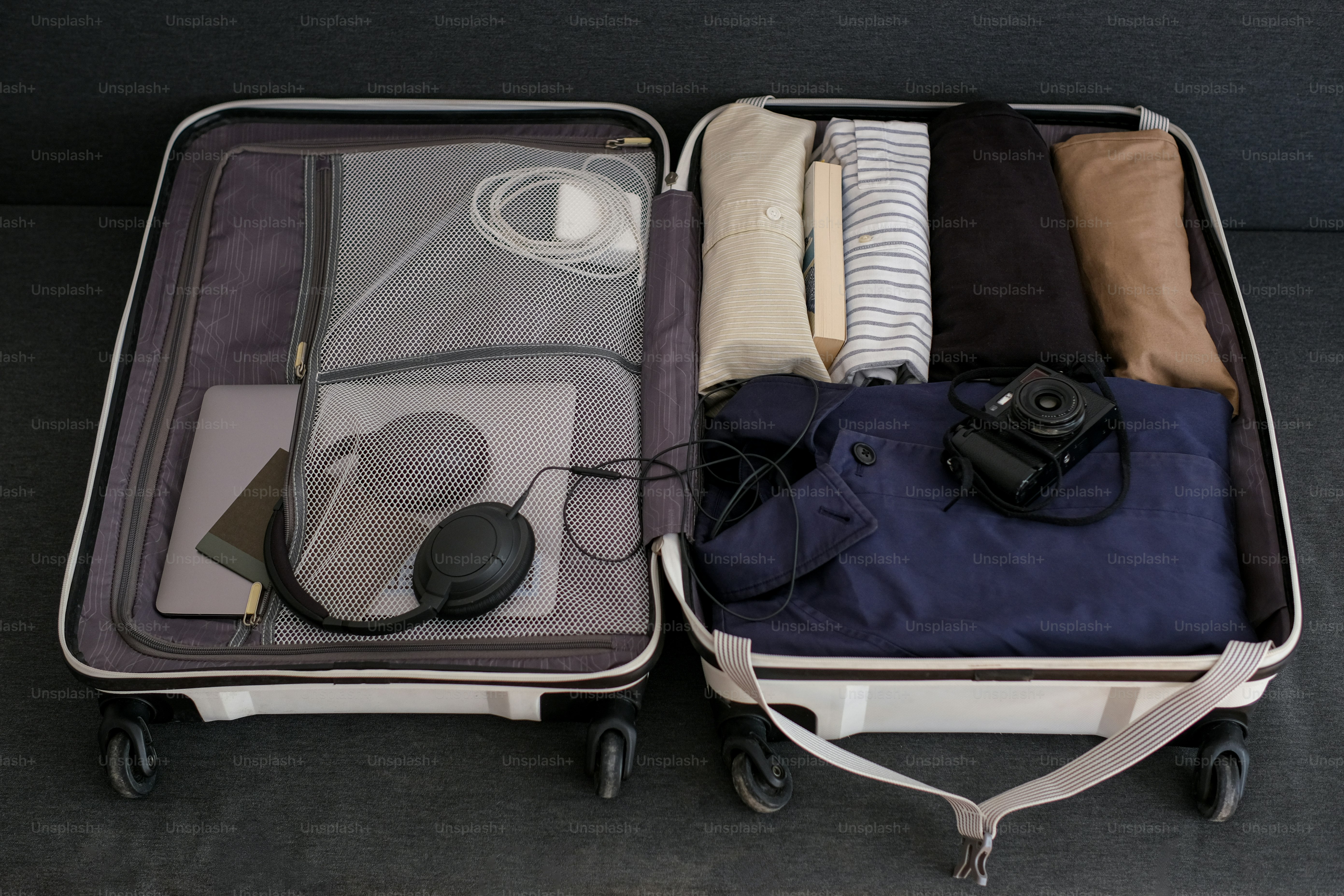 An open suitcase packed with clothes and travel essentials.