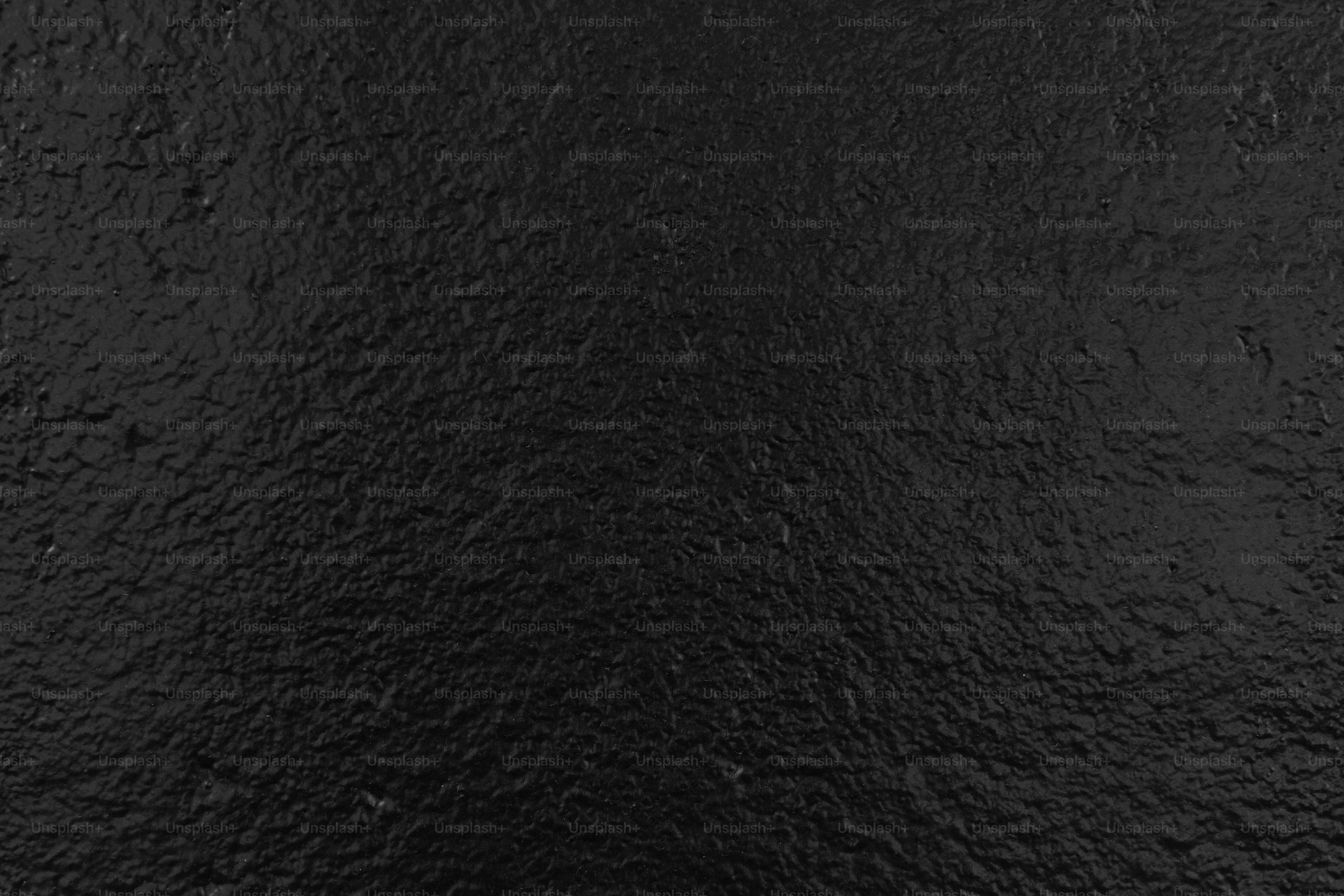 A dark black textured background surface.
