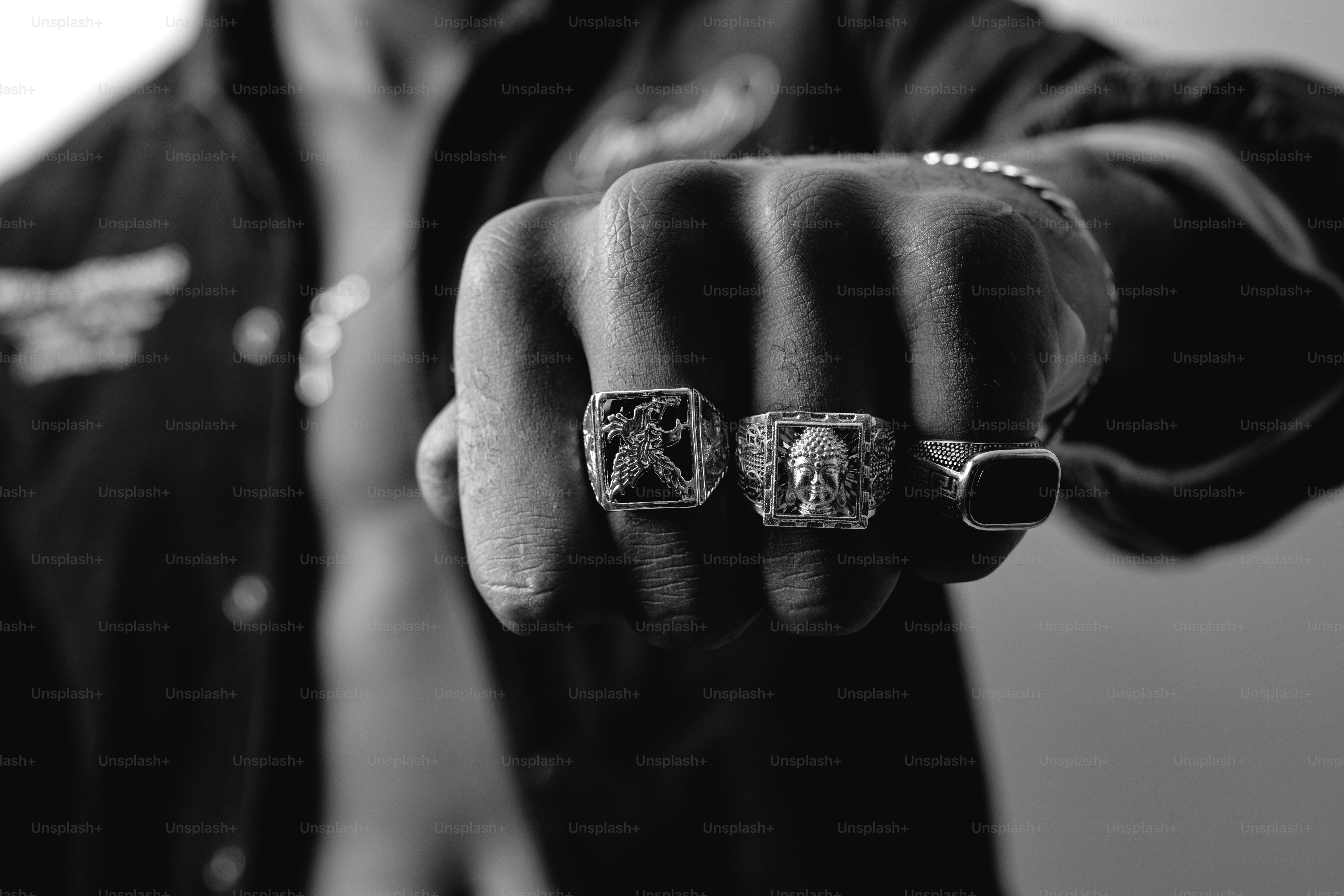 Clenched fist with three rings in black and white. photo – Jewelry ...