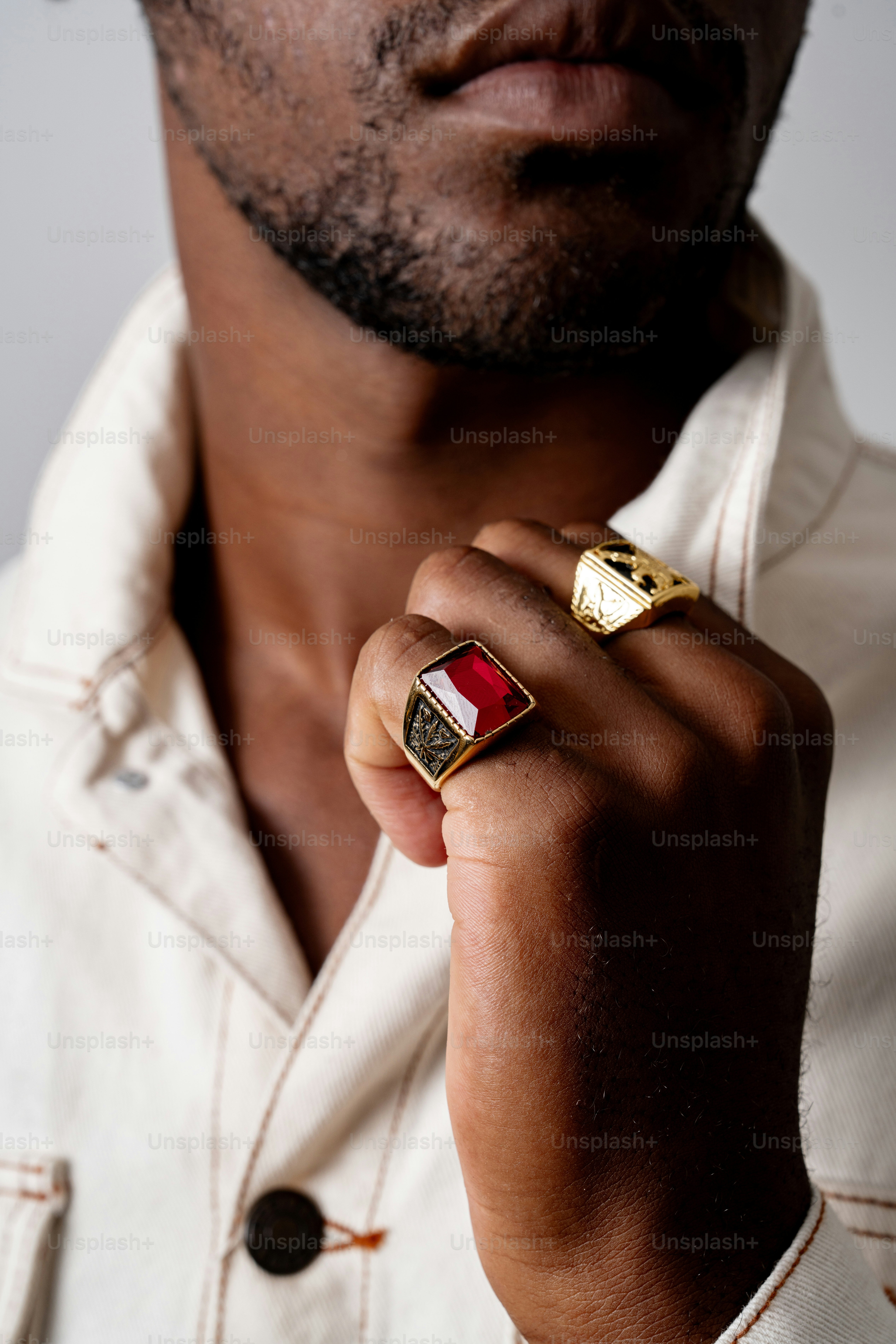 Man wearing a red and gold ring. photo – Luxury Image on Unsplash